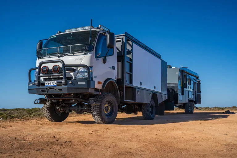 4x4 truck towing caravan in outback