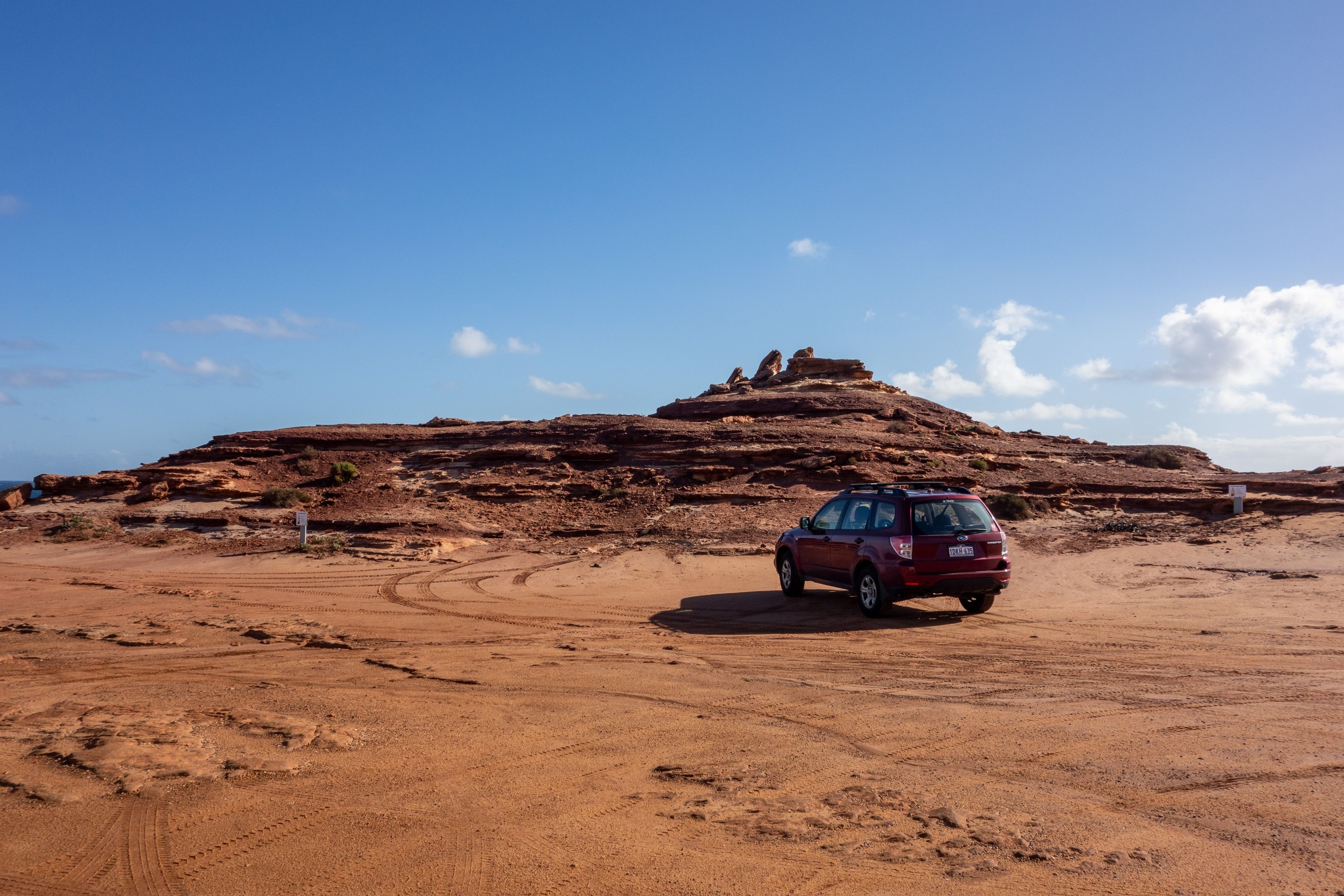 A Subaru on a red dirt landscape in Australia 