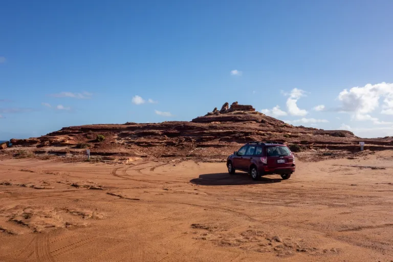 A Subaru on a red dirt landscape in Australia