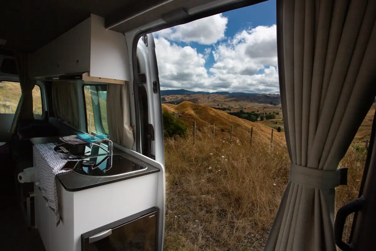 looking onto hills from the interior of an RV