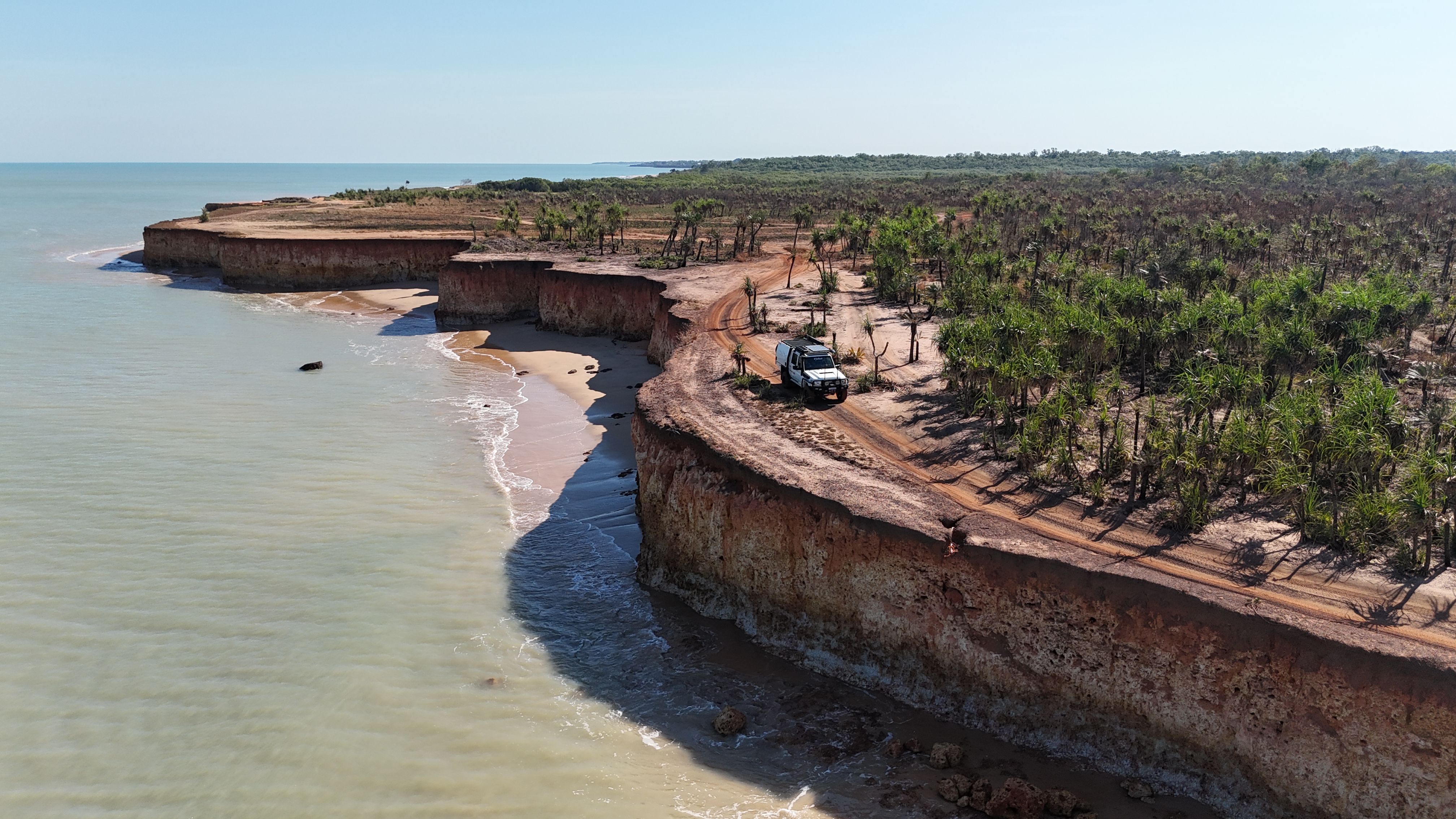 A Toyota LandCruiser 70 Series driving along a coastal cliff in Australia