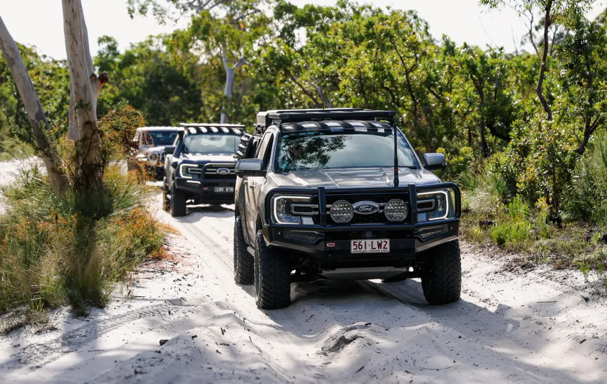 Convoy of 4WDs on a soft sand track on K'Gari