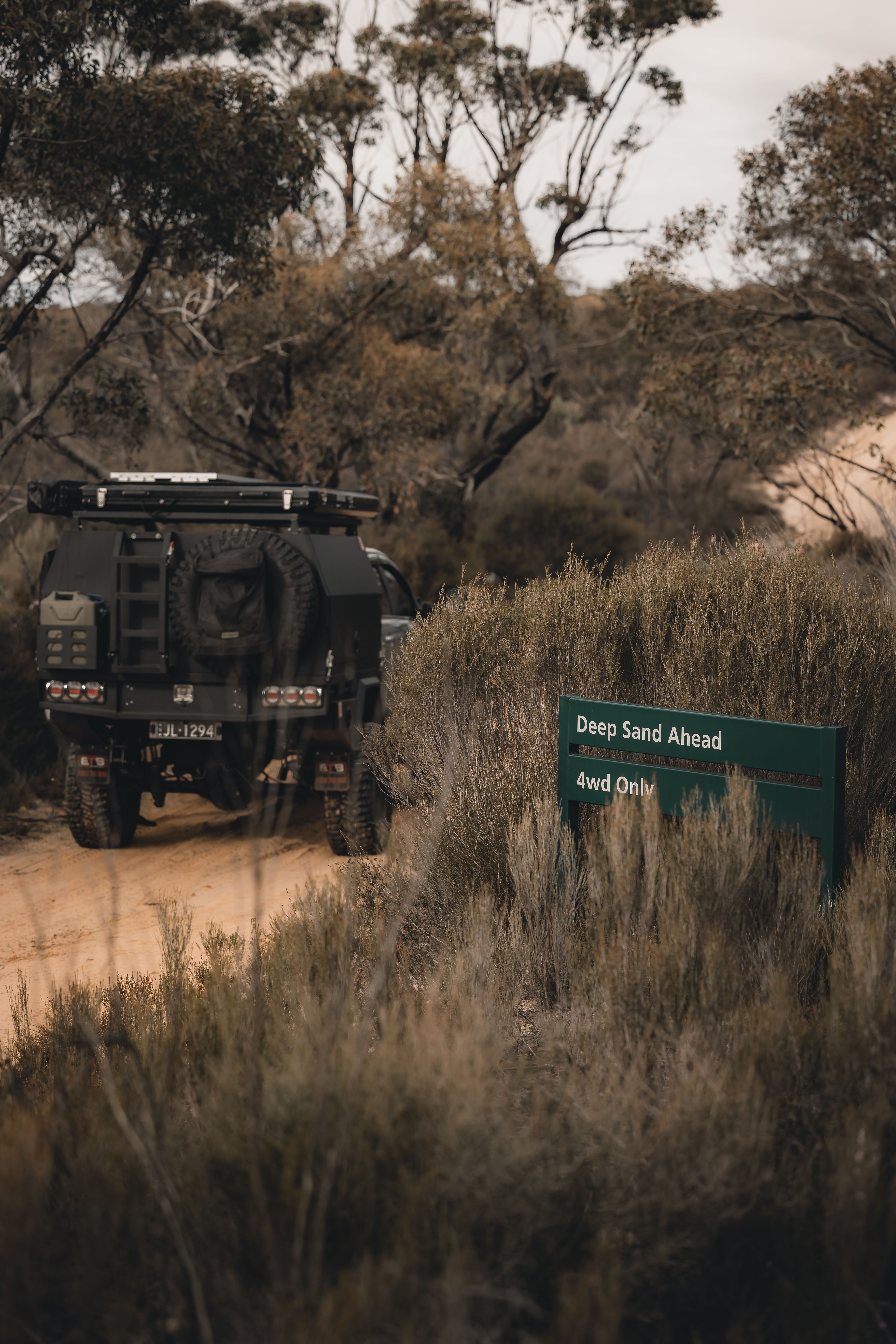 A 4X4 Ford Ranger in Australia with a sign warning of deep sand