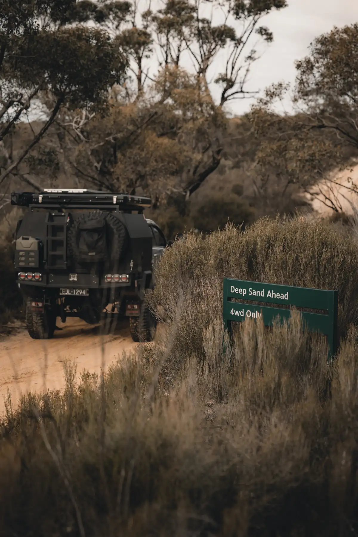 A 4X4 Ford Ranger in Australia with a sign warning of deep sand