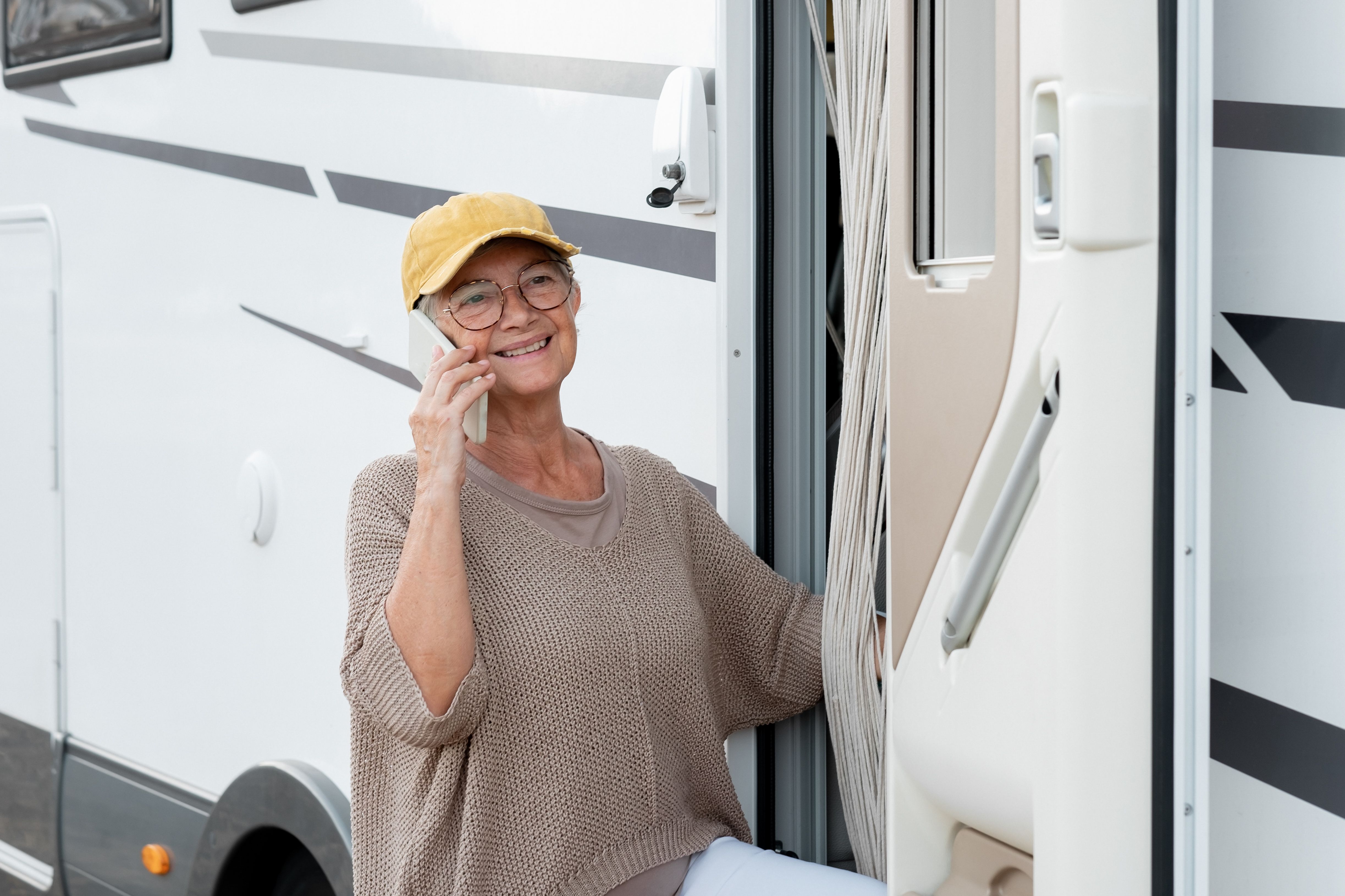 A woman on the phone outside her motorhome