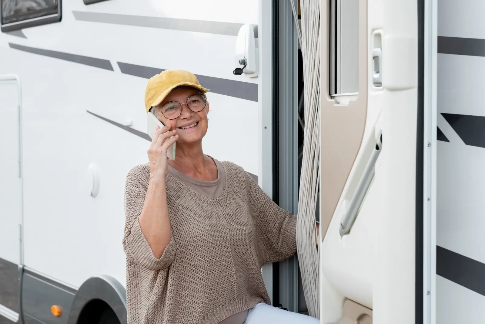 A woman on the phone outside her motorhome