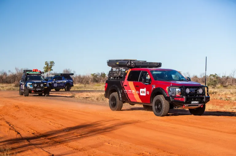 convoy of 4x4s driving though the desert