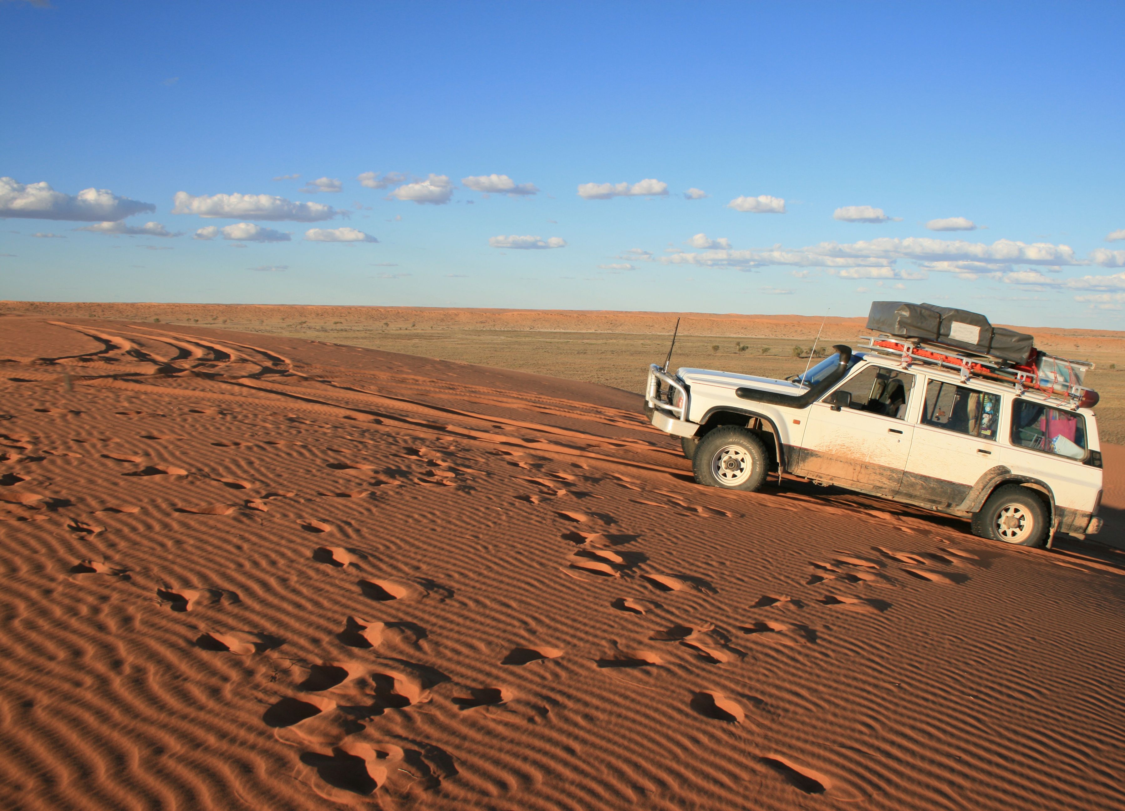A 4X4 mounting the Big Red sand dune in the Simpson Desert, Birdsville, QLD, Australia