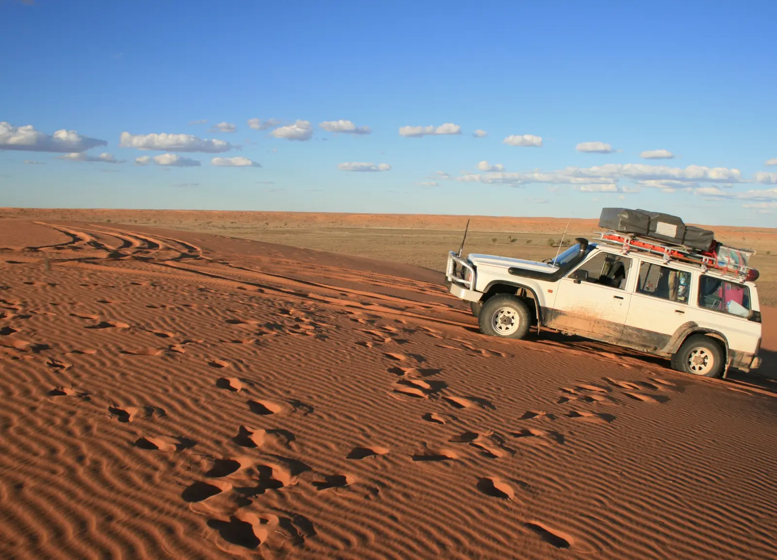 A 4X4 mounting the Big Red sand dune in the Simpson Desert, Birdsville, QLD, Australia