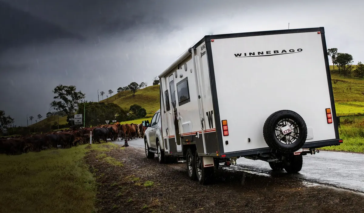 a caravan endures wet weather traffic