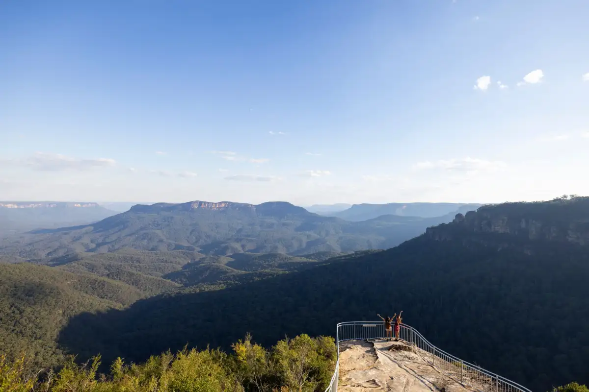 Hikers enjoy the view at the Olympian Rock Lookout, Blue Mountains.