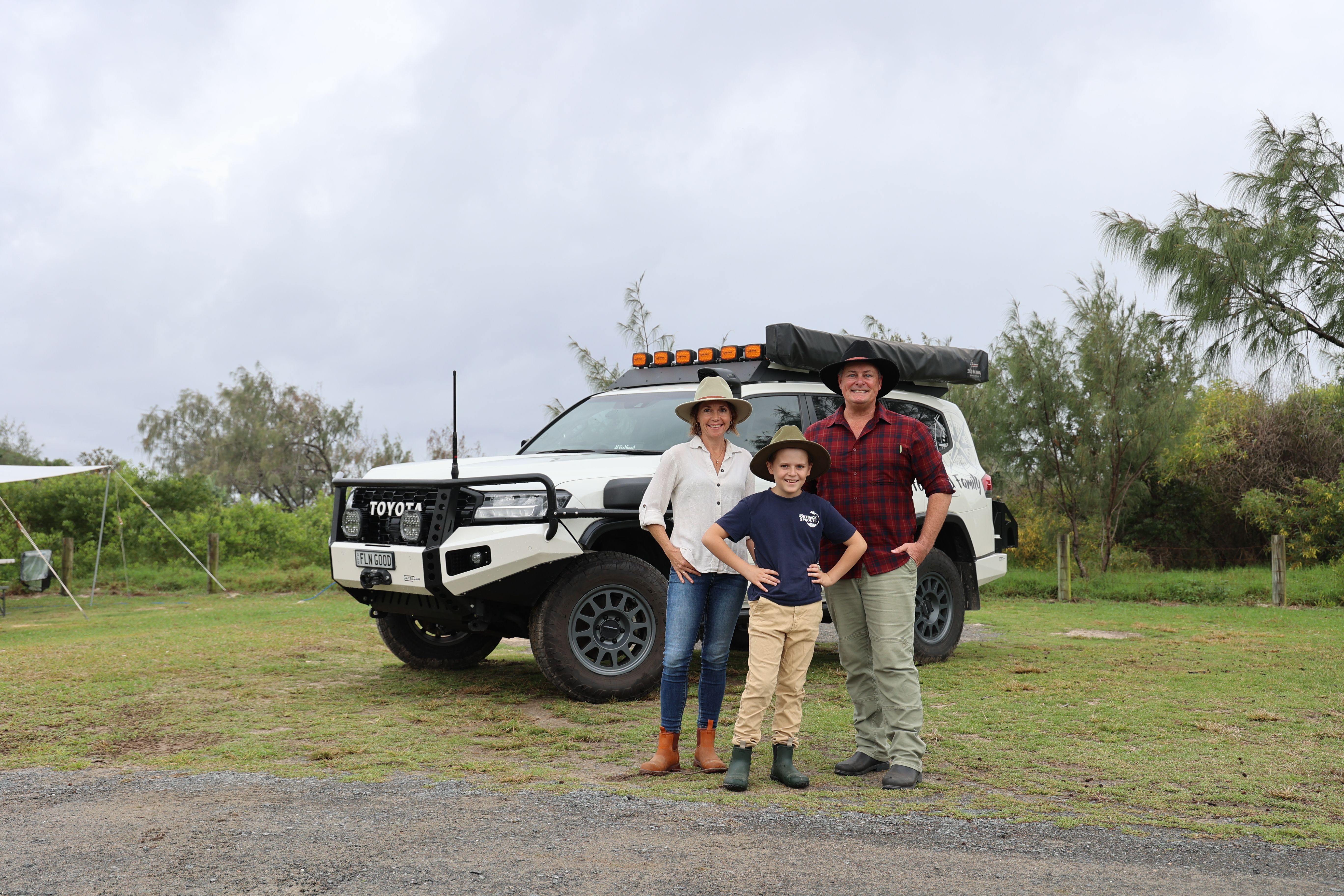 A family of 3 in front of their modified Toyota LandCruiser