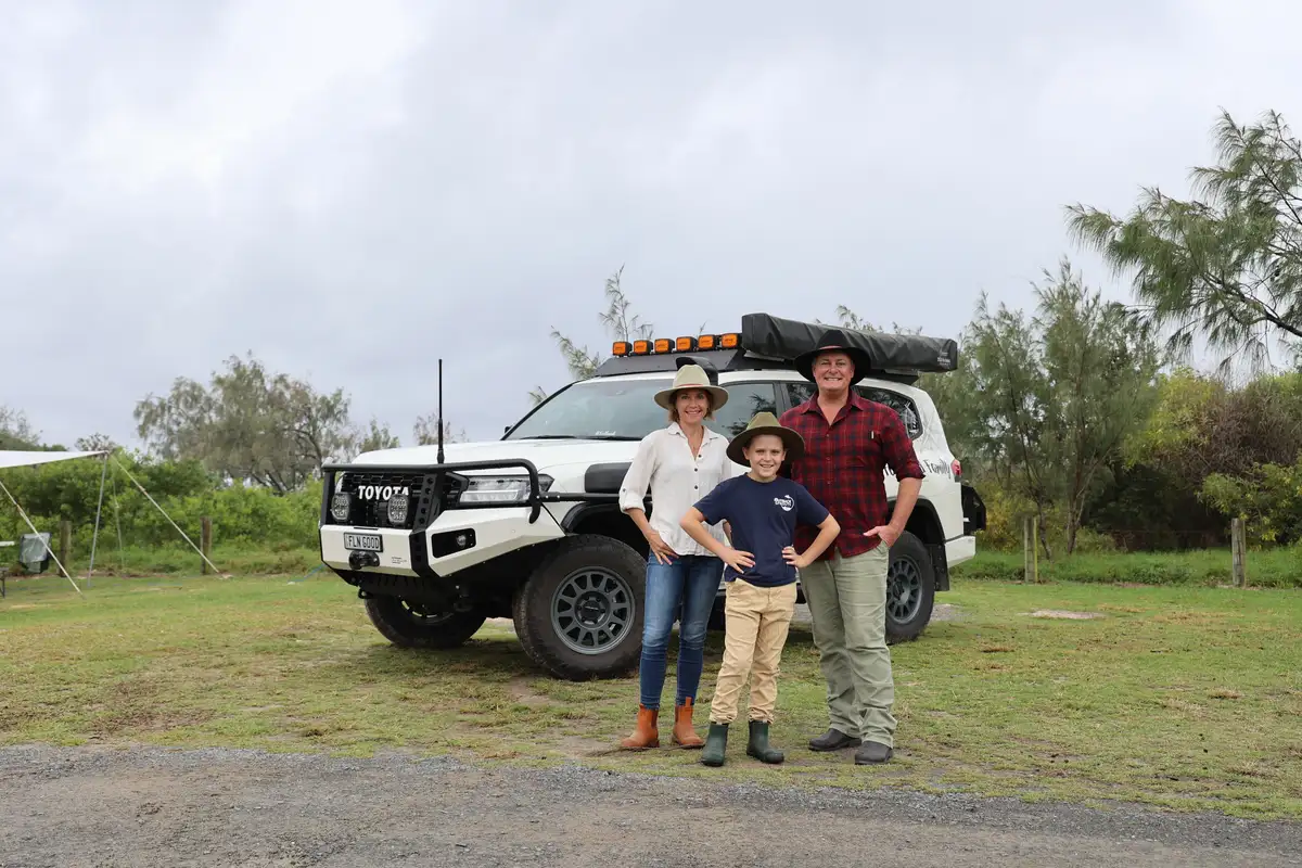 A family of 3 in front of their modified Toyota LandCruiser