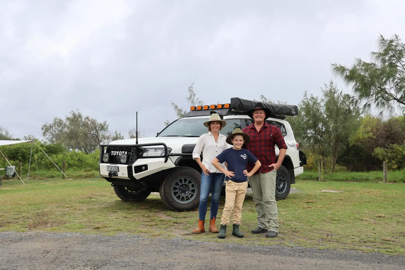 A family of 3 in front of their modified Toyota LandCruiser