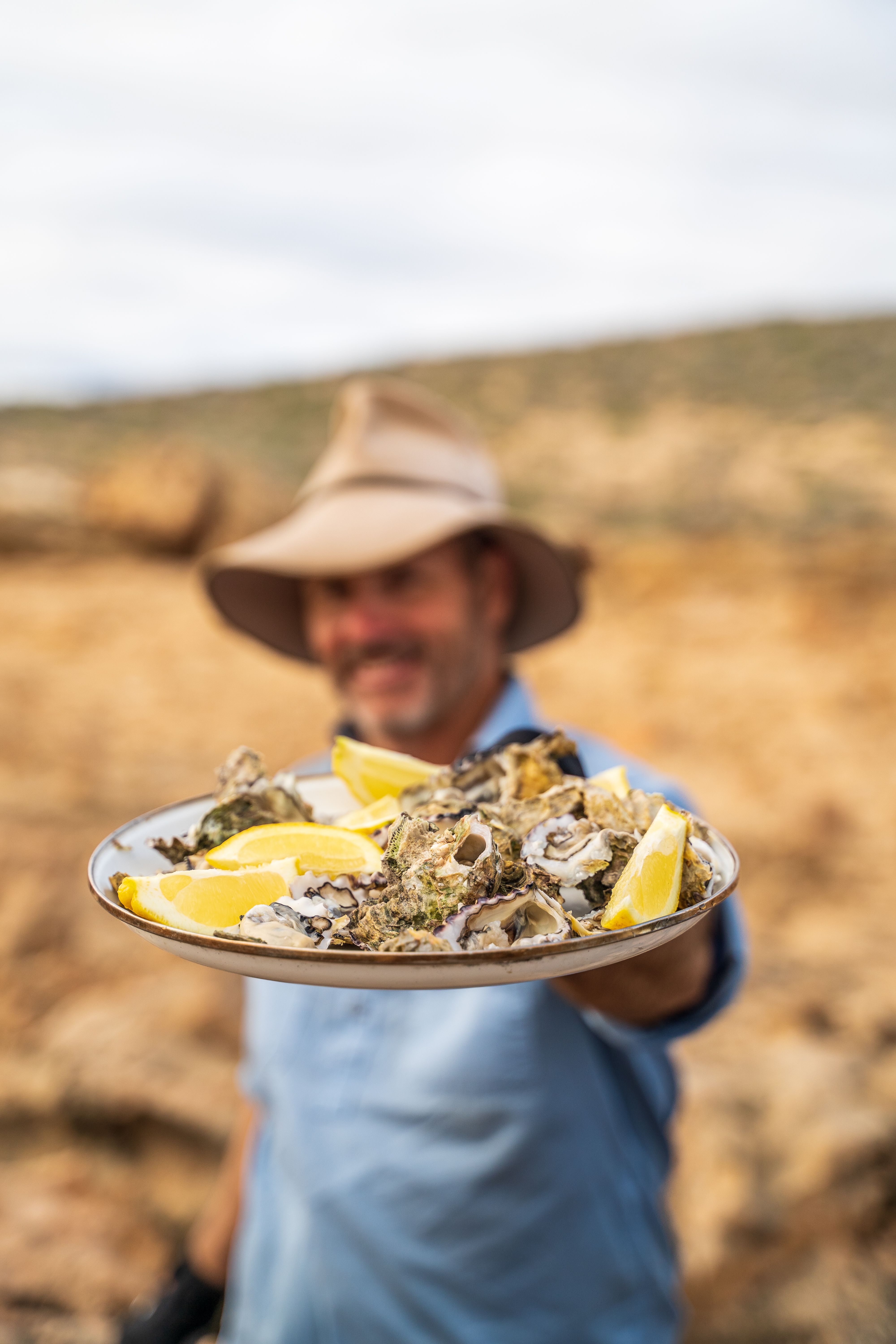 Pat Callinan holding a plate with oysters and lemon