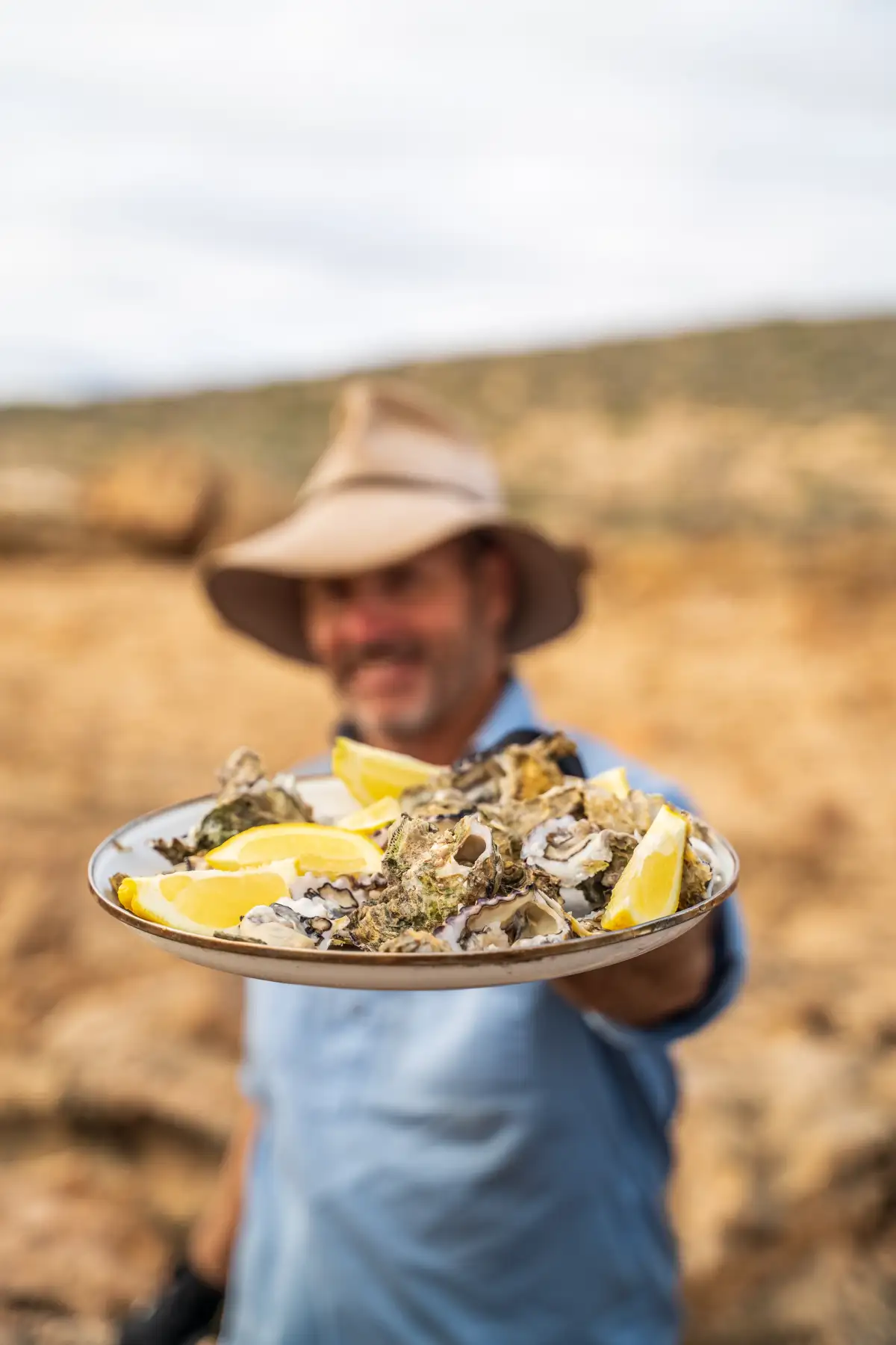 Pat Callinan holding a plate with oysters and lemon