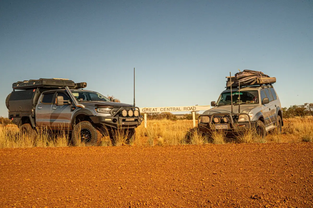 two 4WDs parked in front of a Great Central Road sign