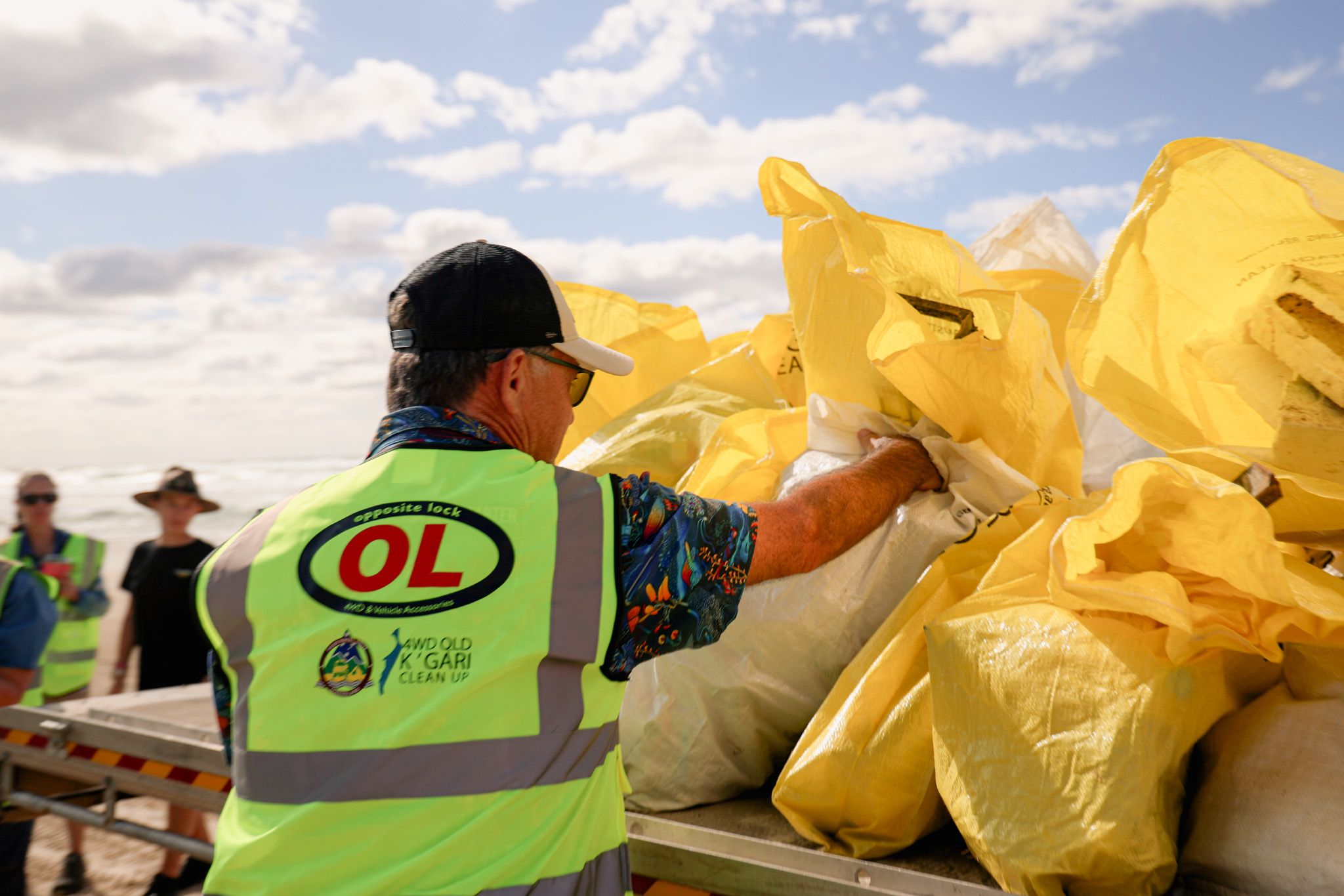 A man loading rubbish into a ute following the K'Gari Clean Up
