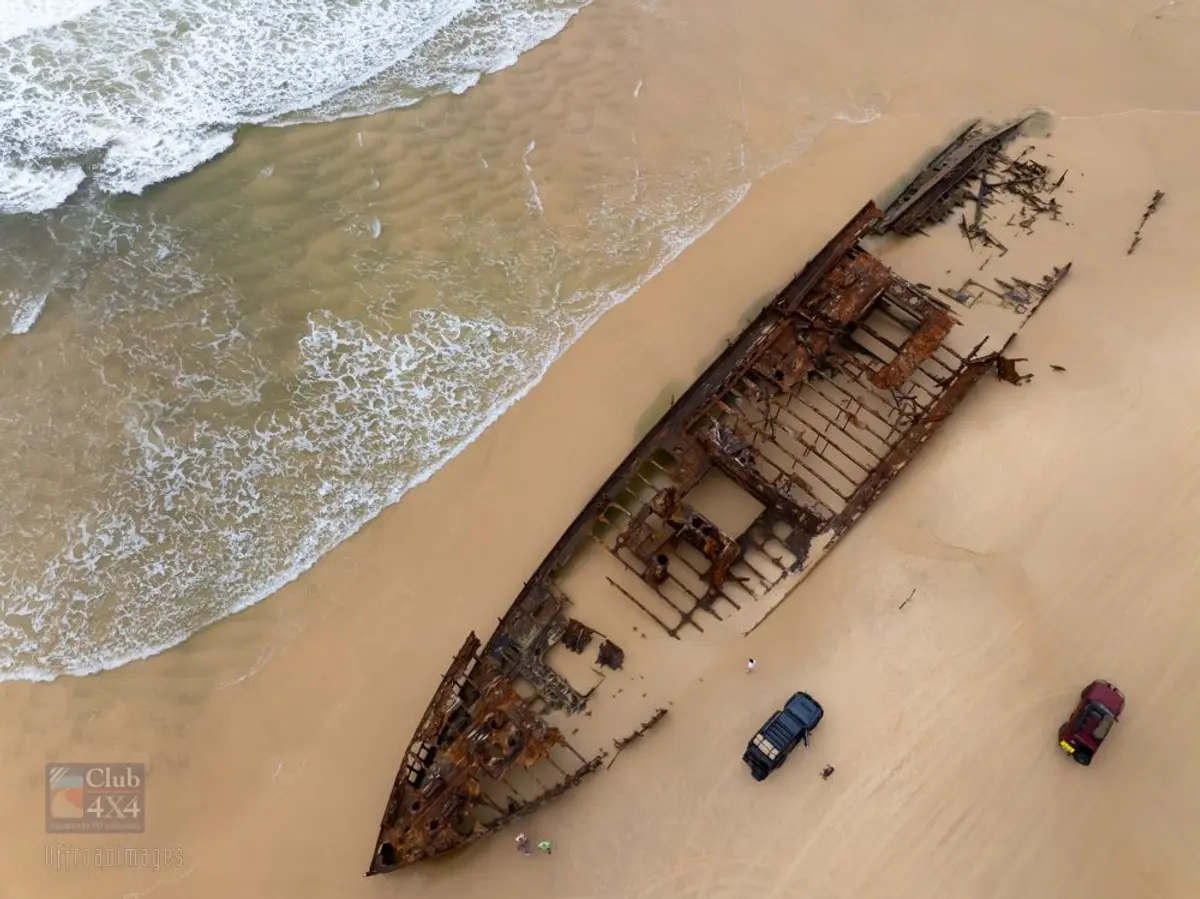 maheno shipwreck birds eye drone with 4wds on beach