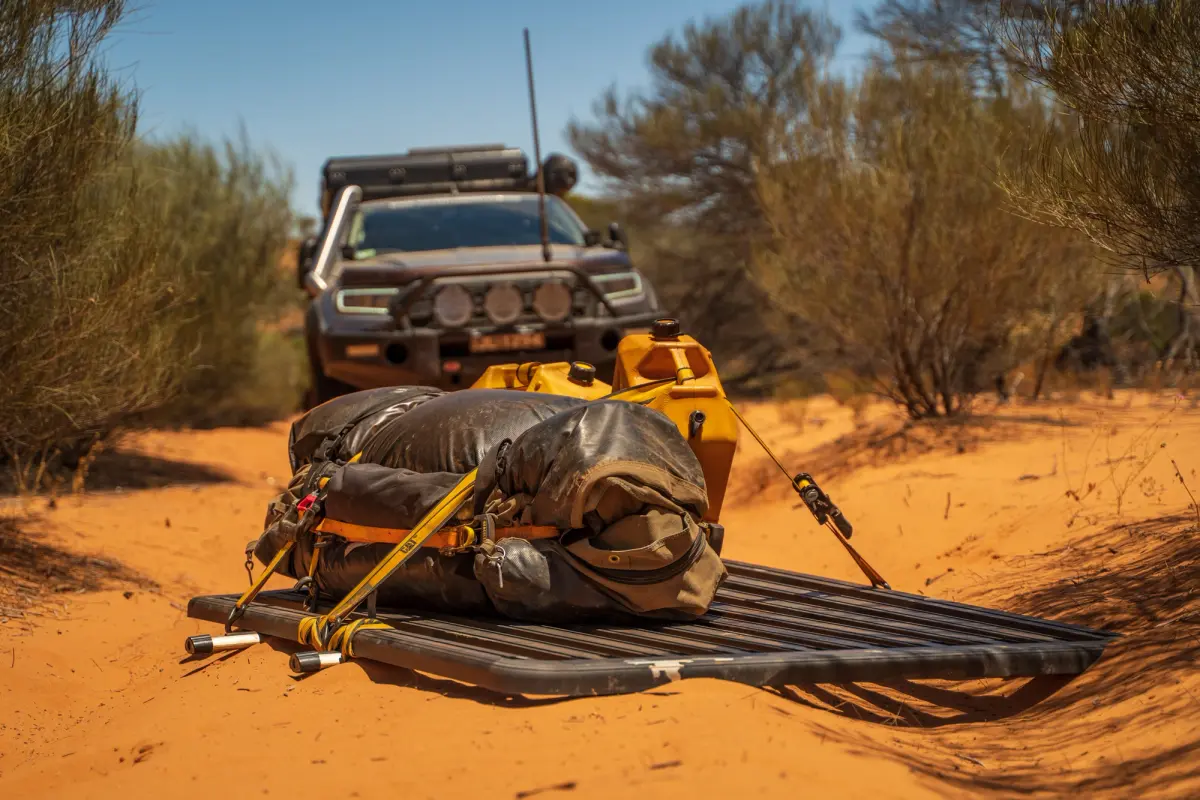 Touring gear on a platform in the Outback of Australia with a 4X4 ute in the background