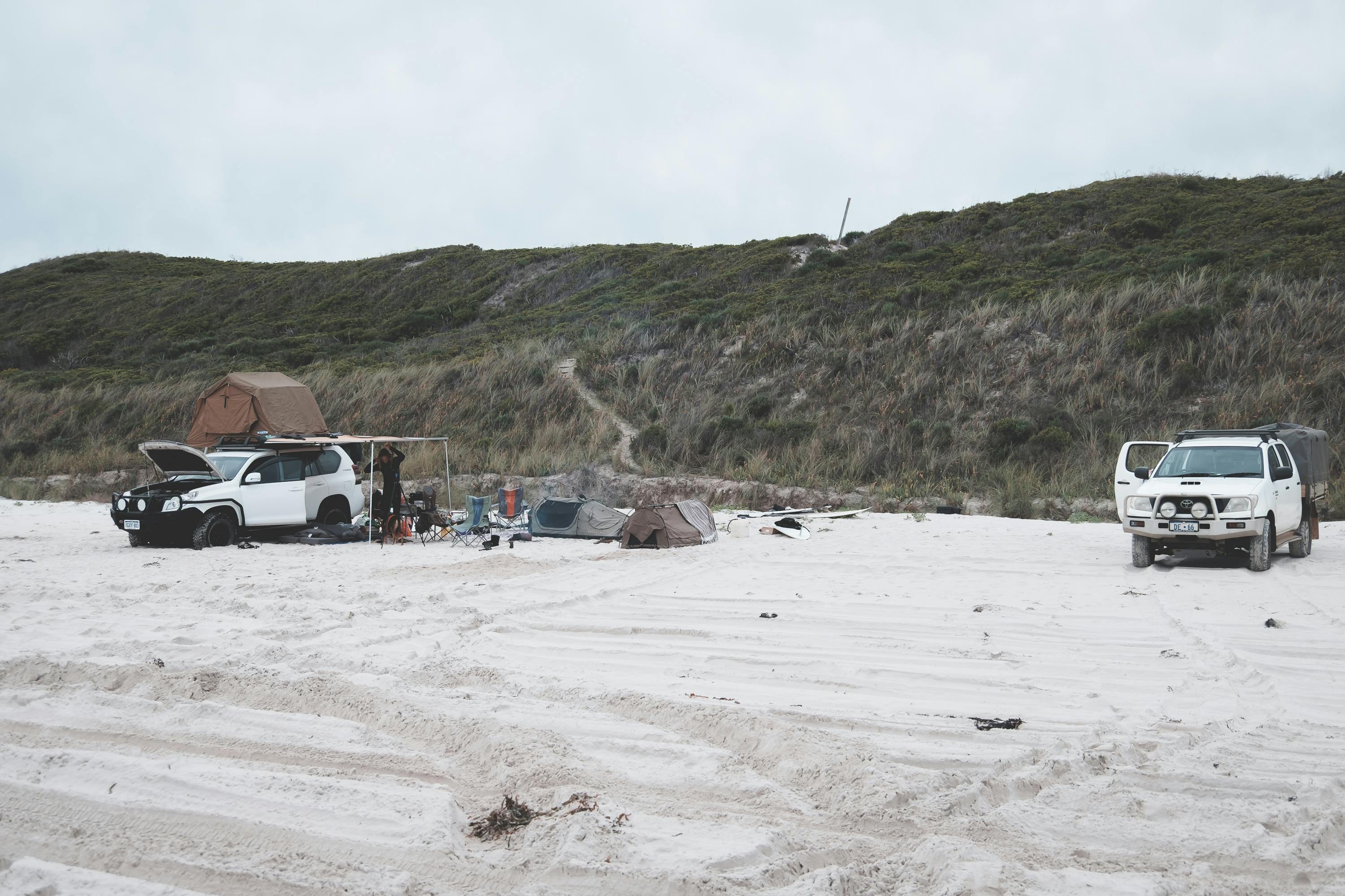 2 4X4s parked at camp on a beach in Australia