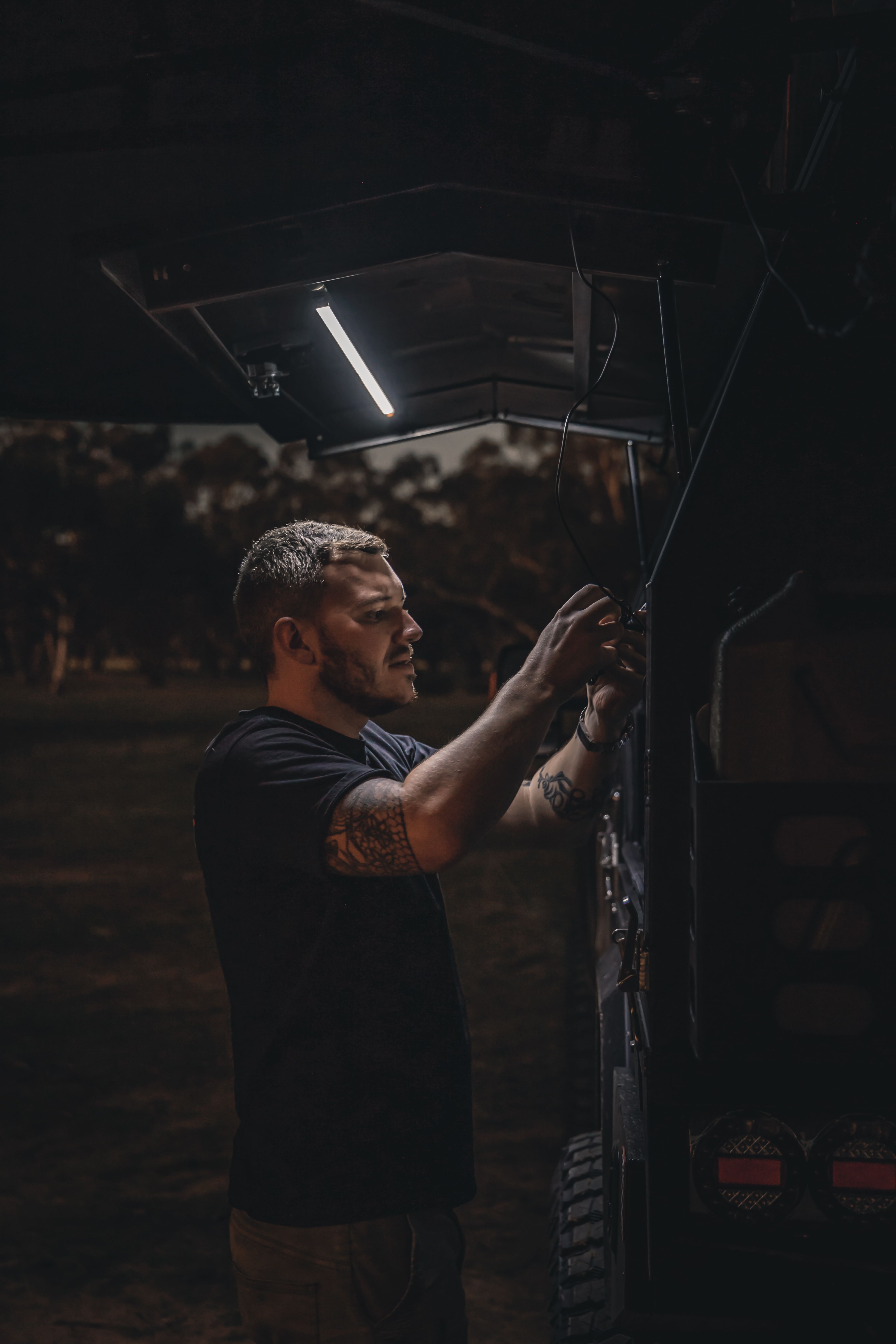 Josh Leonard under the light of his 4X4 Ford Ranger's canopy