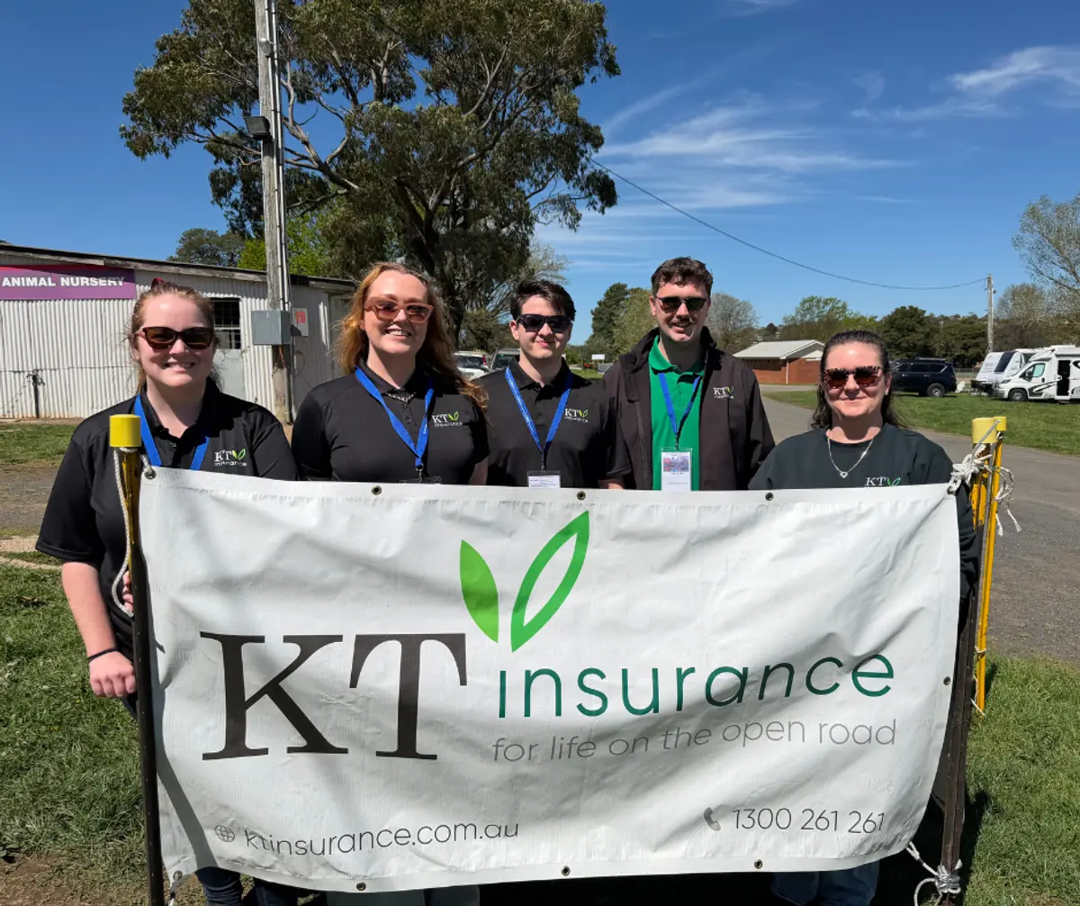 KT Insurance representatives with a sign