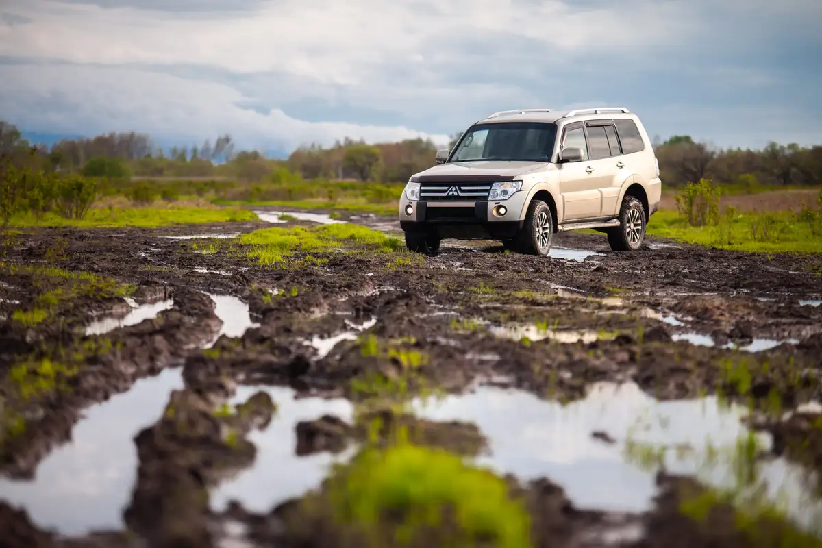 Mitsubishi Pajero off-road on a muddy track