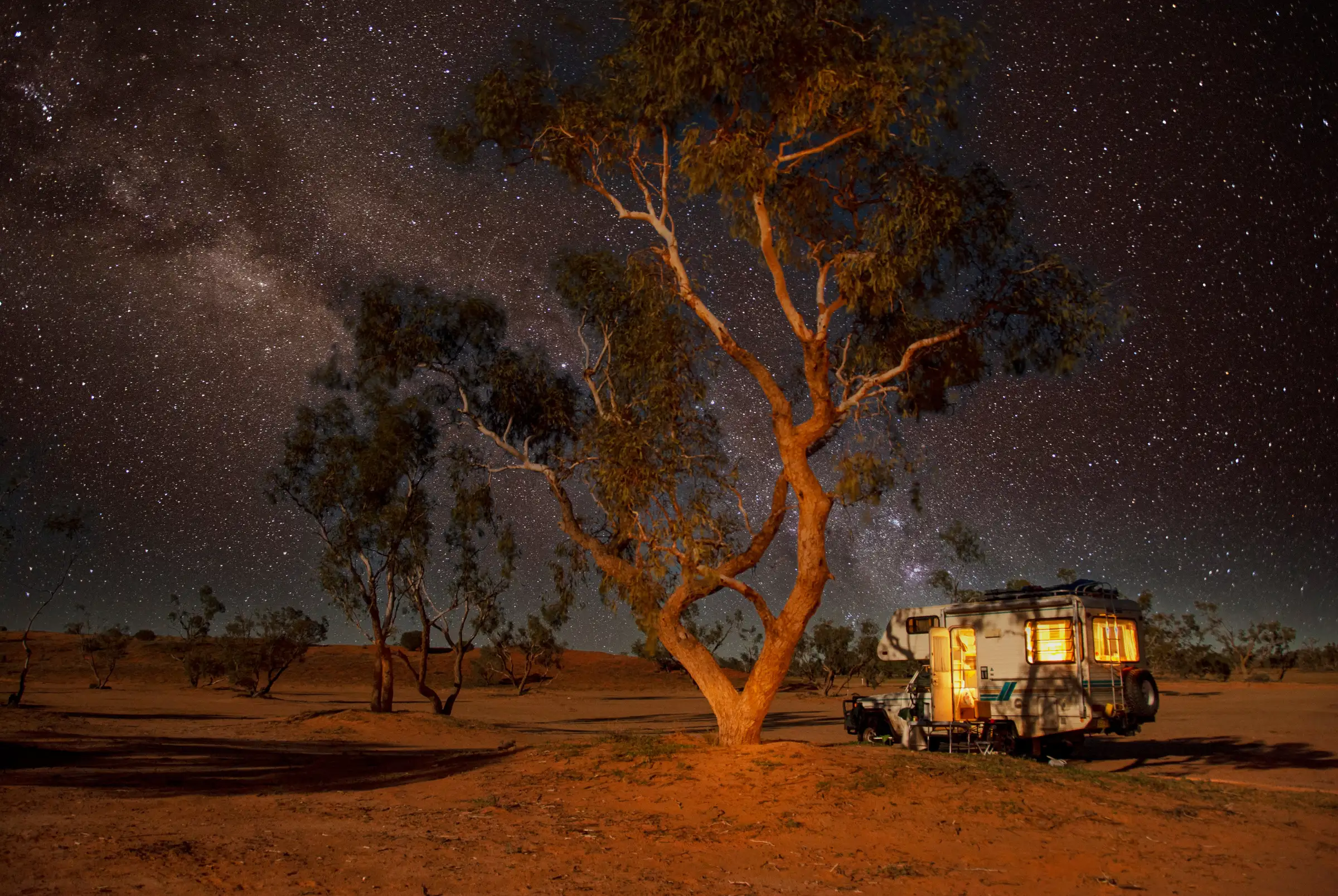 A slide on camper in Outback Australia under a sky with the Milky Way