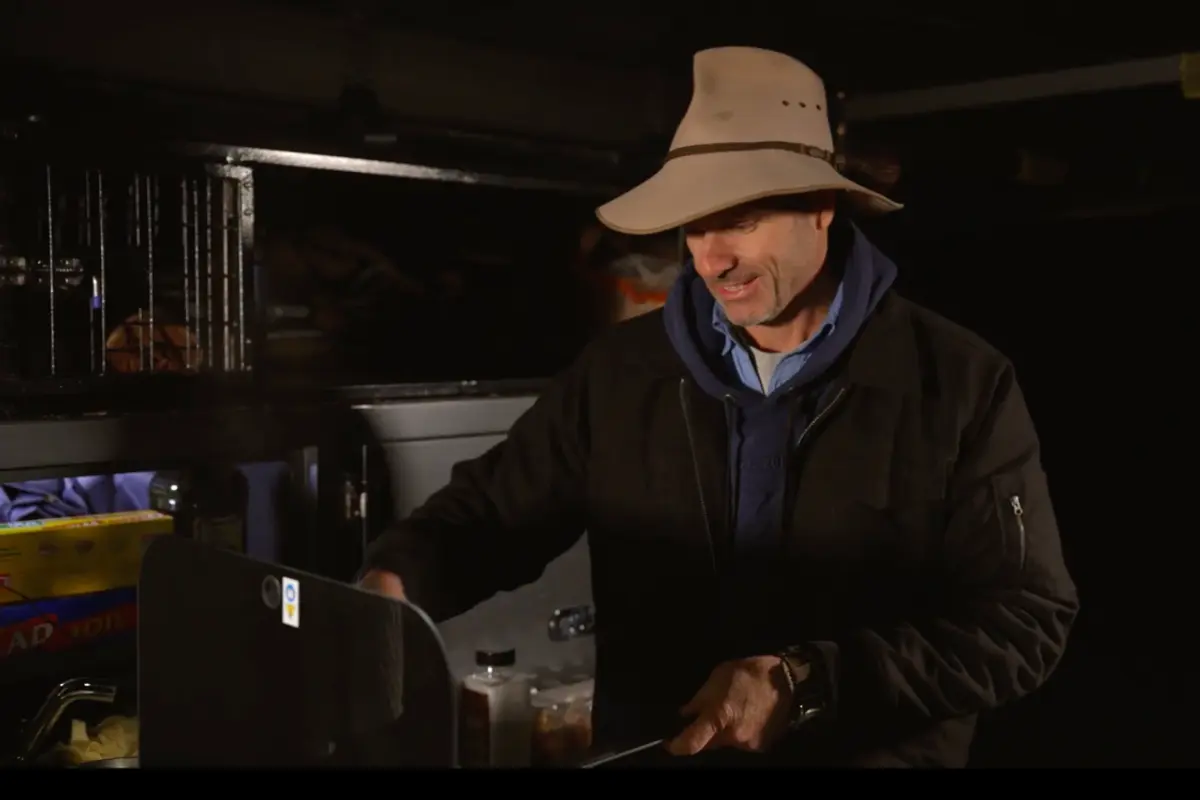 Pat Callinan cooking at campsite