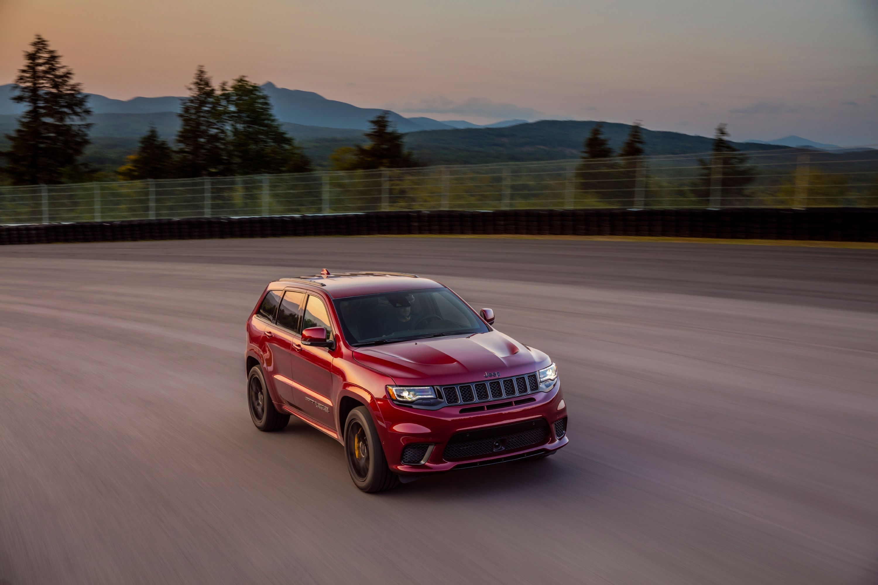 A red Jeep Grand Cherokee Trackhawk on a test track