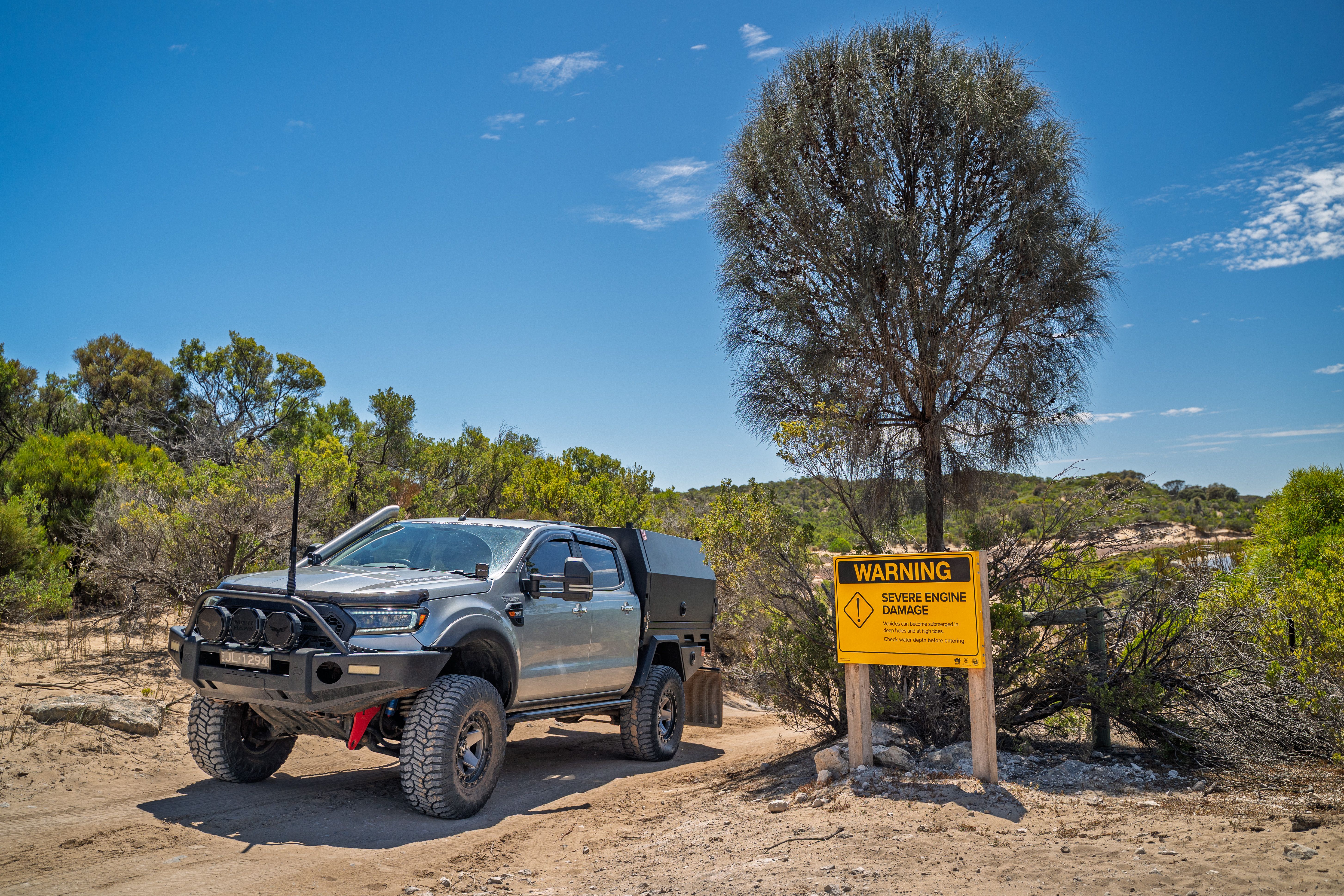4X4 Ford Ranger next to warning sign