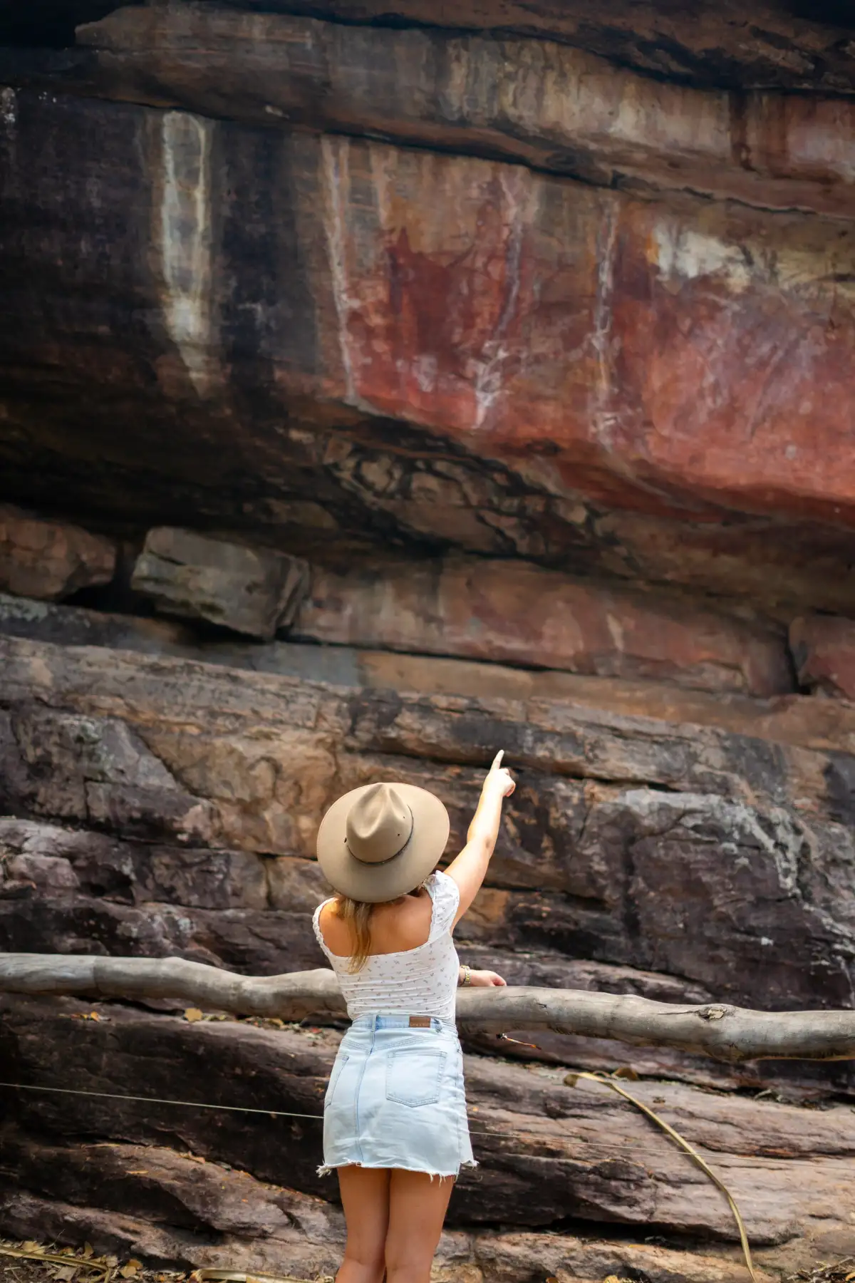 woman pointing at rocks