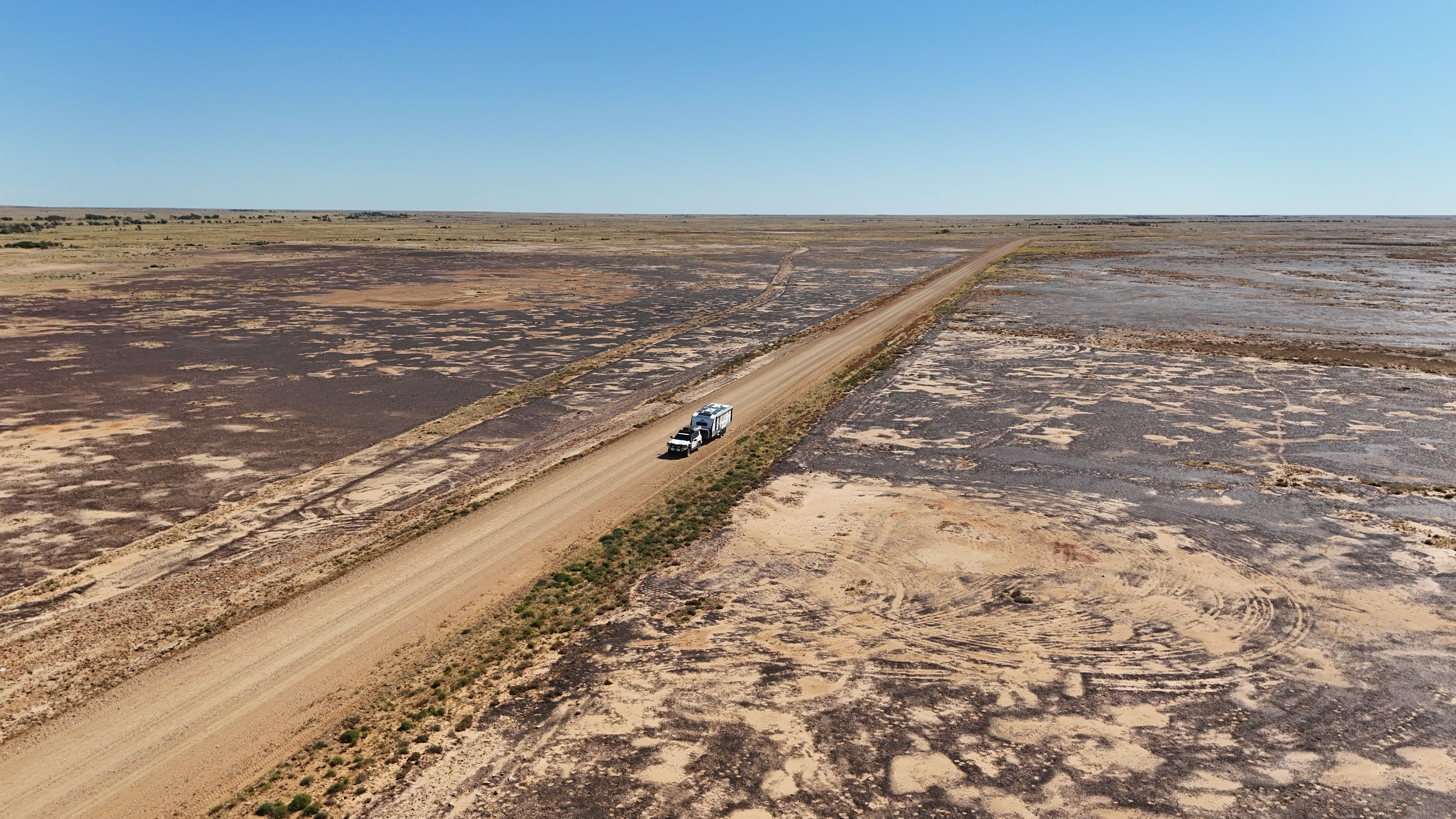 A 4X4 towing a caravan through Outback Queensland