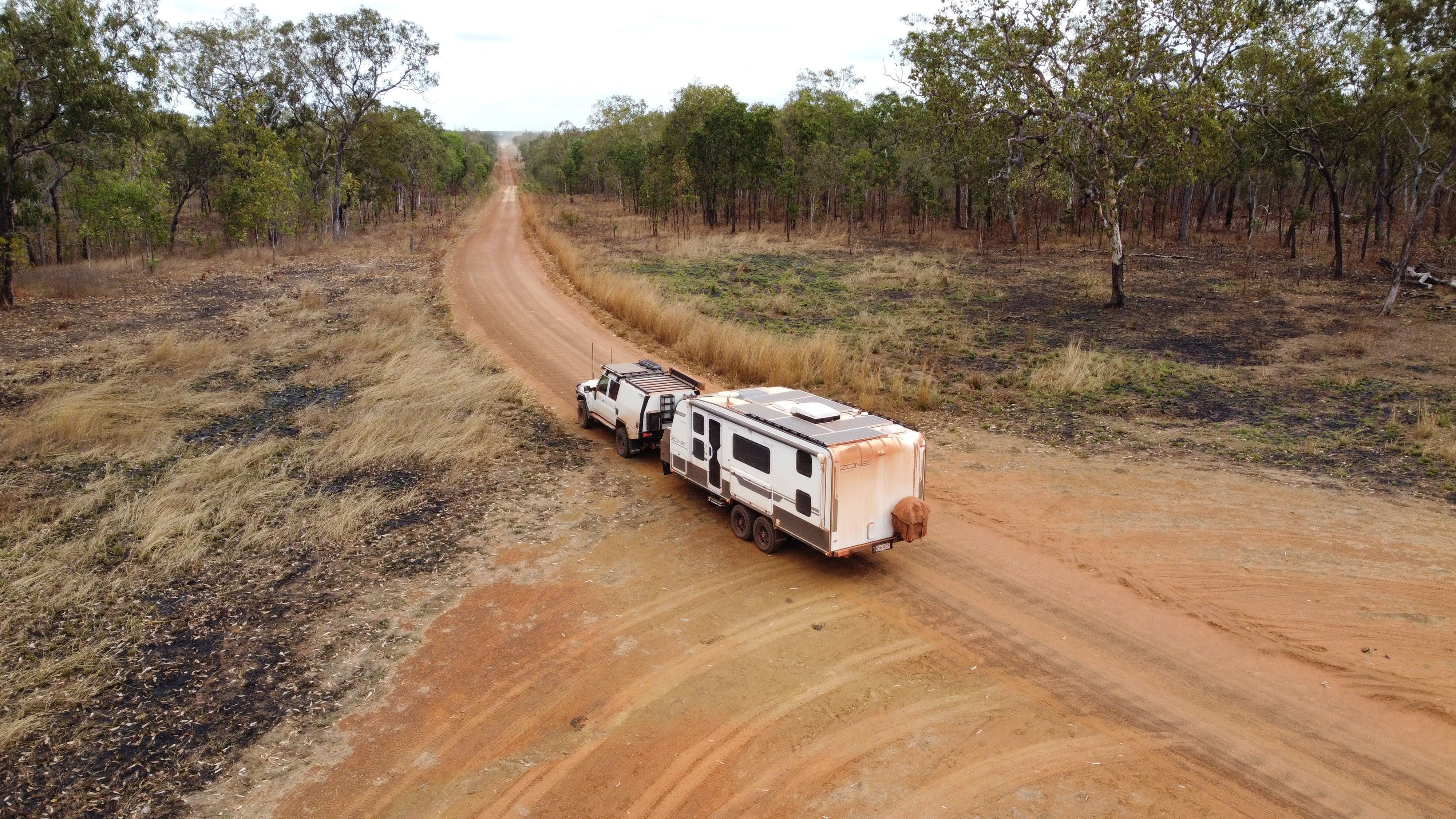 A 4X4 towing a caravan through the Australian bush