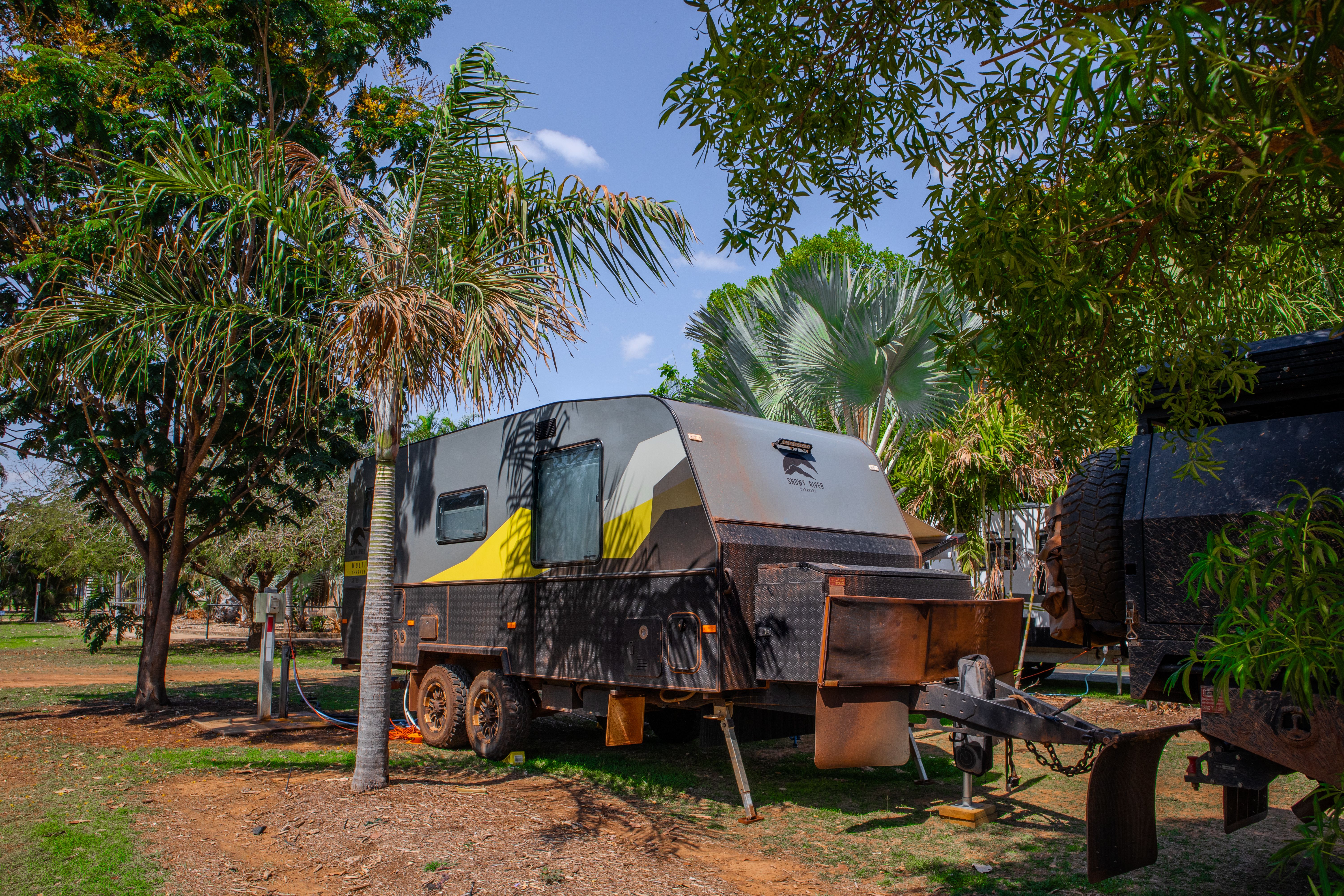 Caravan in a caravan park surrounded by vegetation