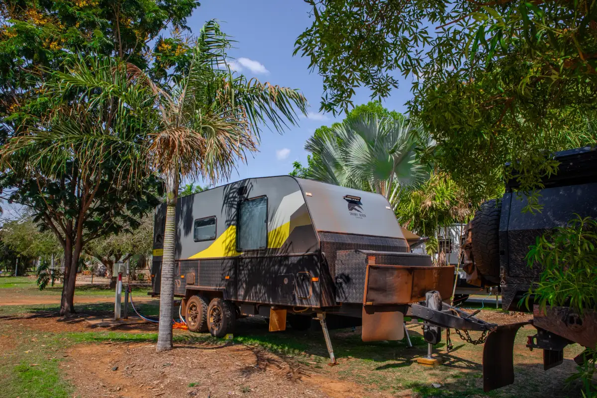 Caravan in a caravan park surrounded by vegetation