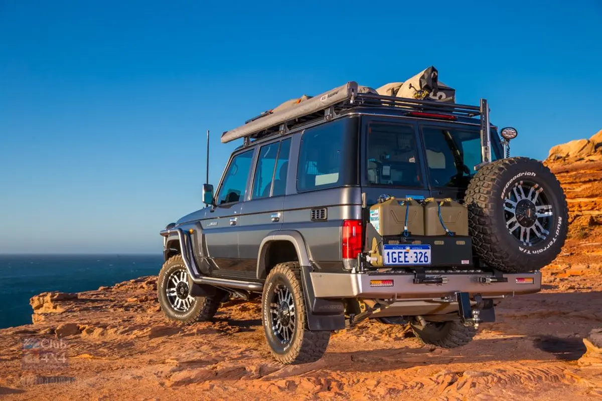 modified landcruiser 4wd offroad carrying gas on rear tailgate