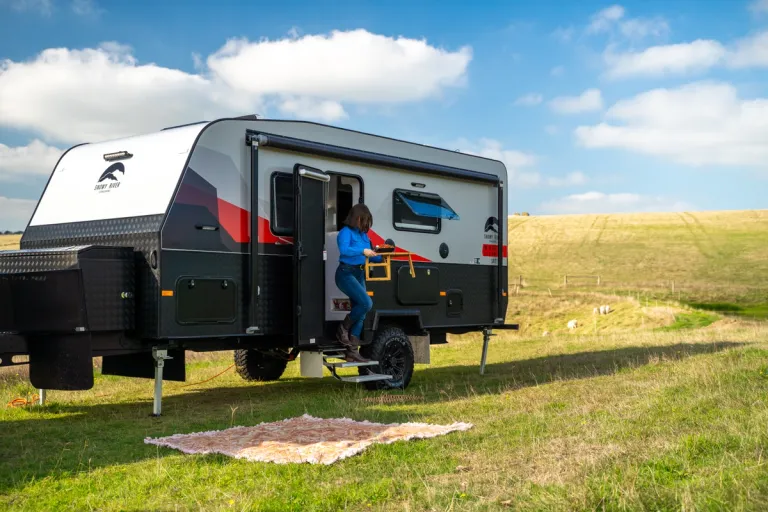 woman at door of caravan