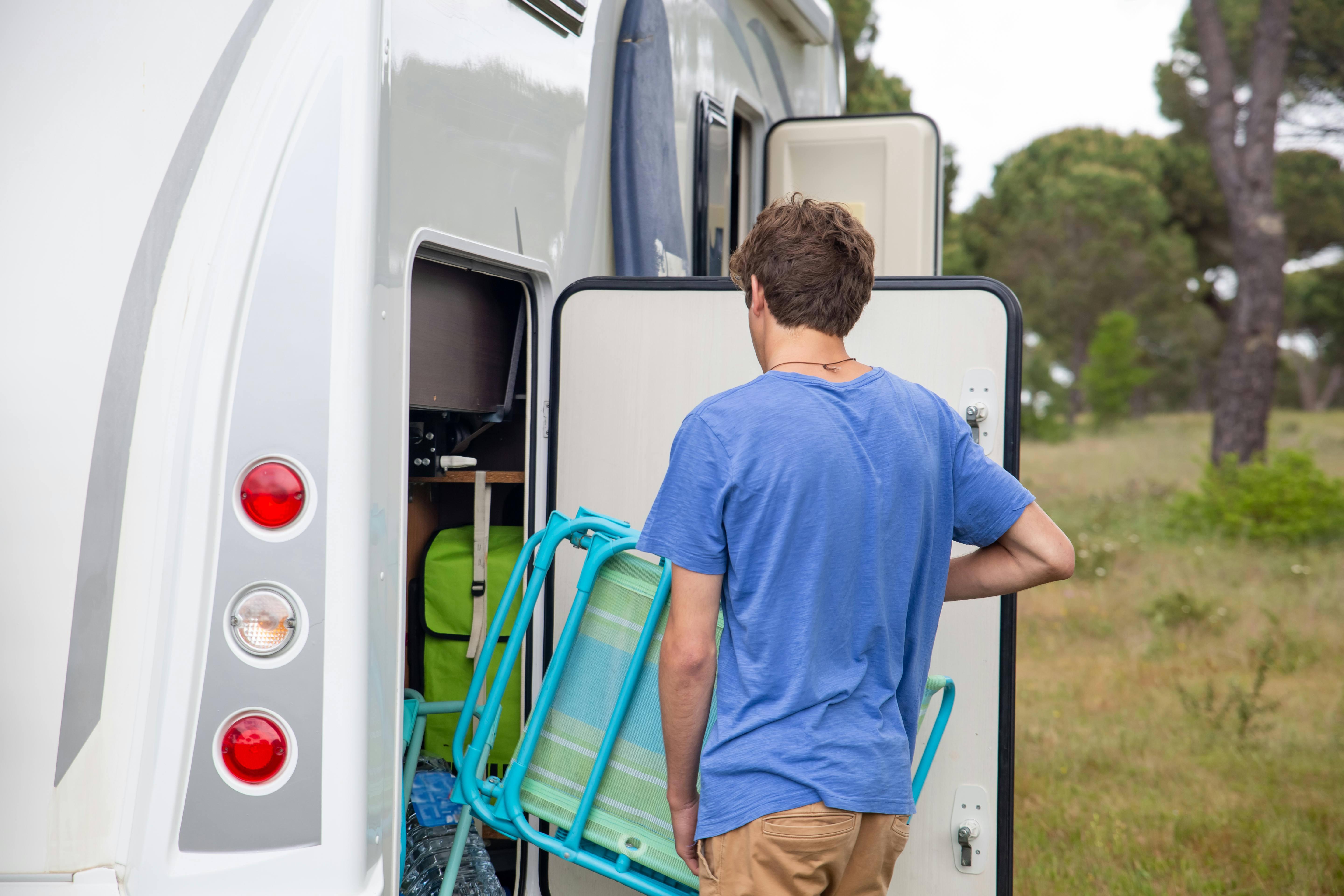 man packing an RV