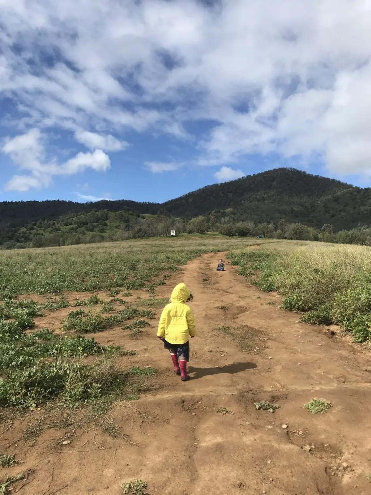 A group of people standing on top of a grass covered field Description automatically generated