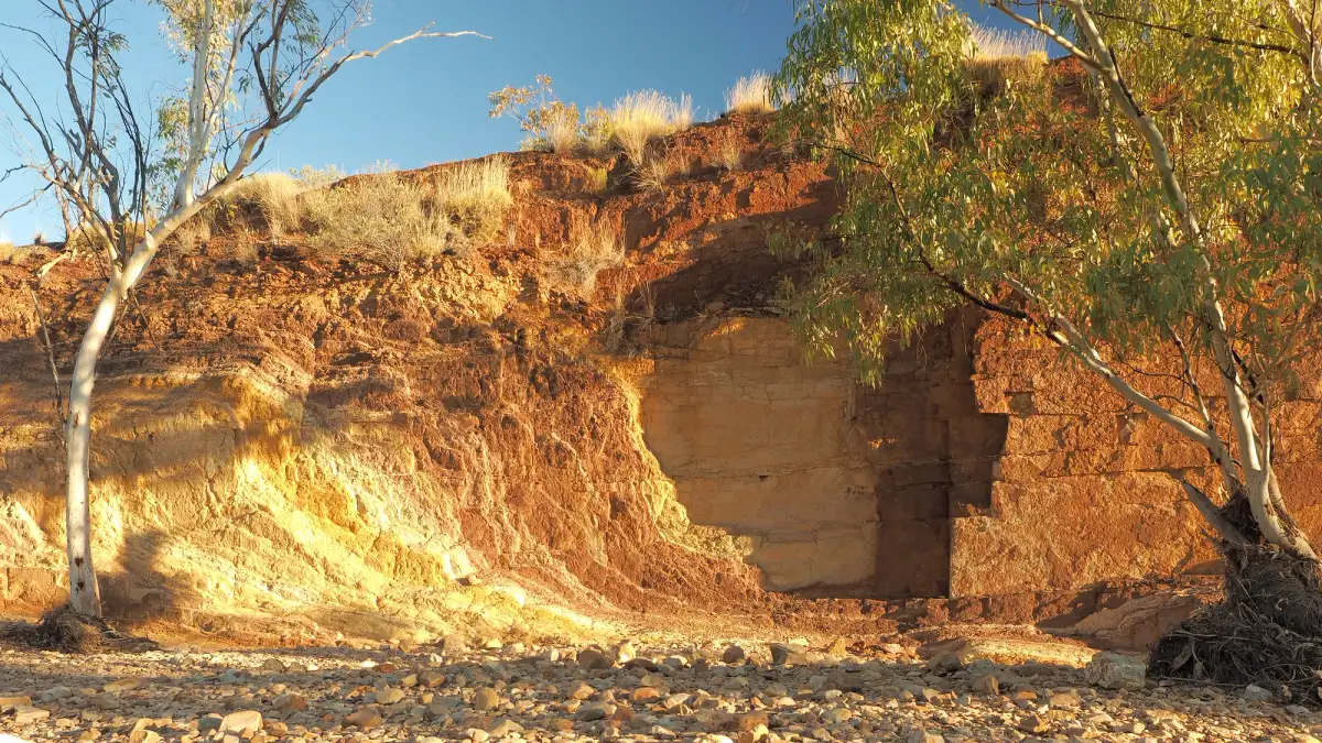 Upwards Ochre lines in the banks of a creek at sunset in the McDonnell Ranges, place of indigenous Ochre mining, Alice Springs, Australia, July 2015