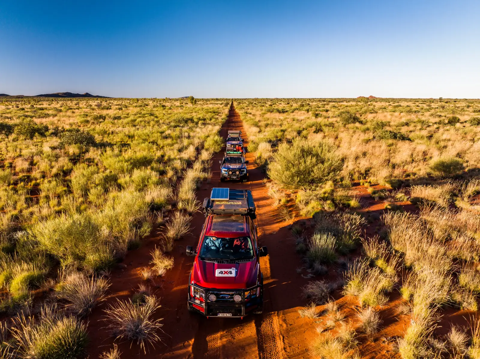 convoy of 4wds driving through the outback