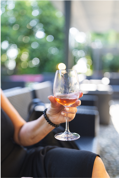 Donna beve vino naturale in esterno
