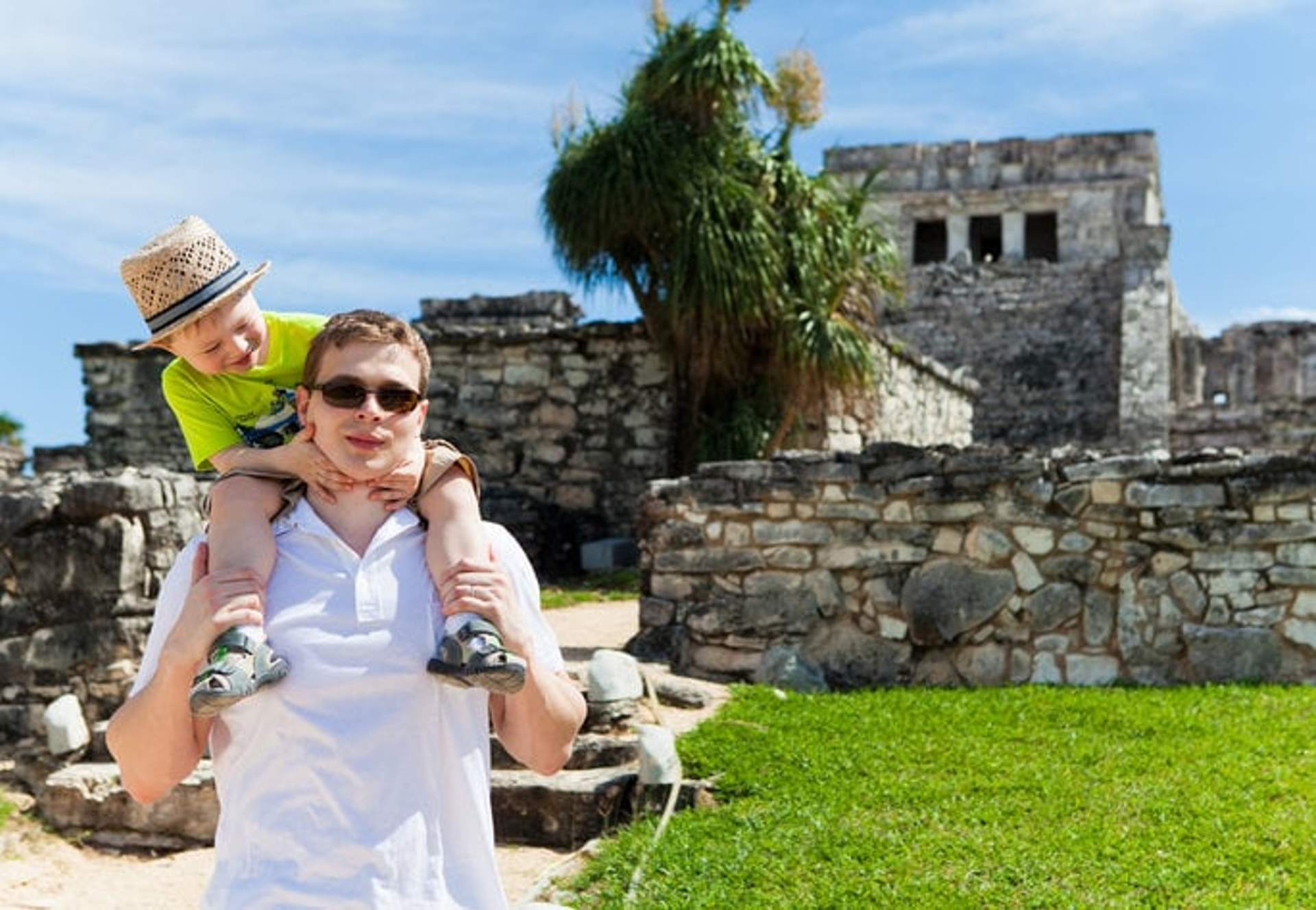 Father and son exploring Tulum ruins, a kid-friendly tour in Cancun.