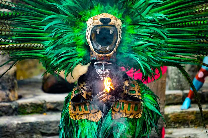 Traditional Mayan dancer wearing a jaguar headdress during an ancestral ritual ceremony inspired by ancient Maya culture