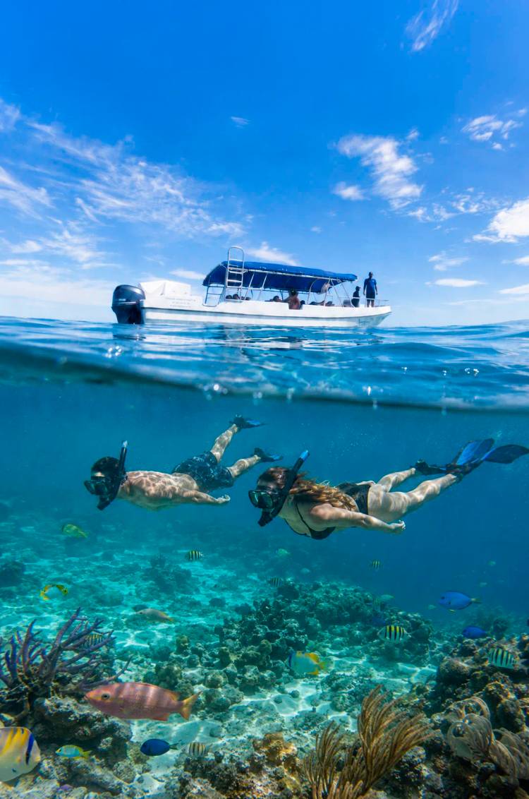 Couple on an Akumal snorkeling tour with a Cancun Adventures' tender boat.