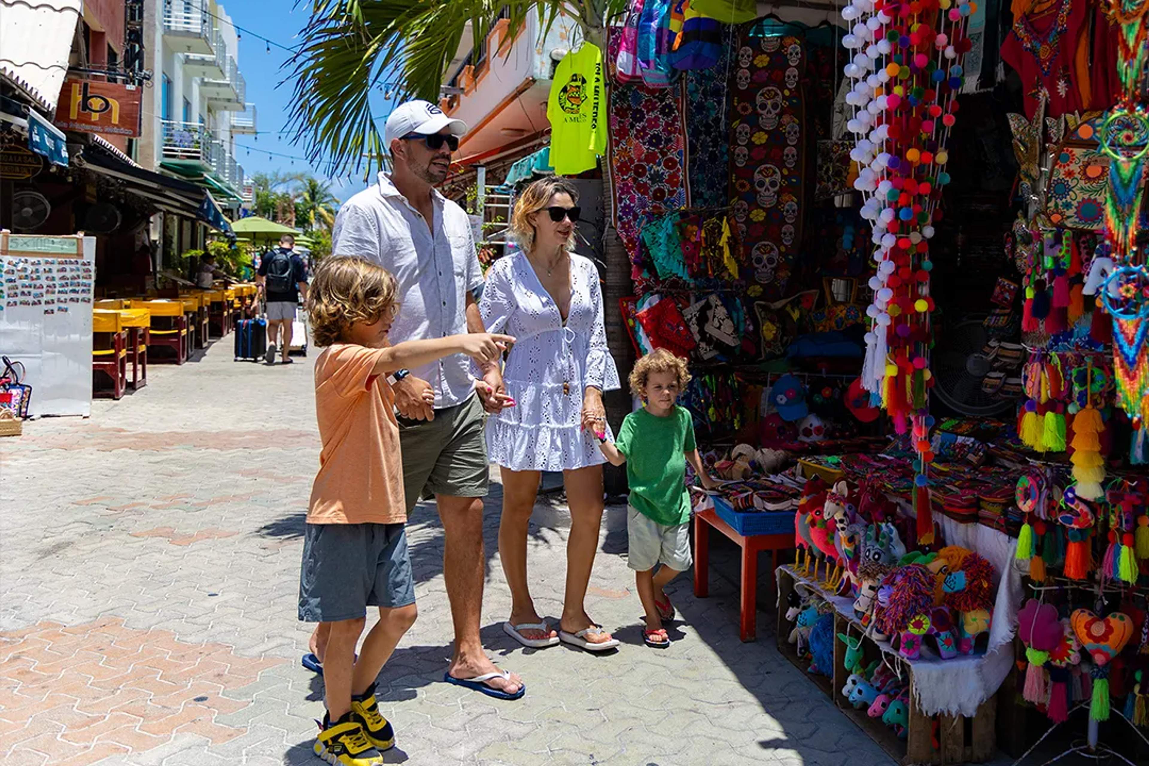 Family exploring colorful local shops and artisan markets during a Riviera Maya cultural tour
