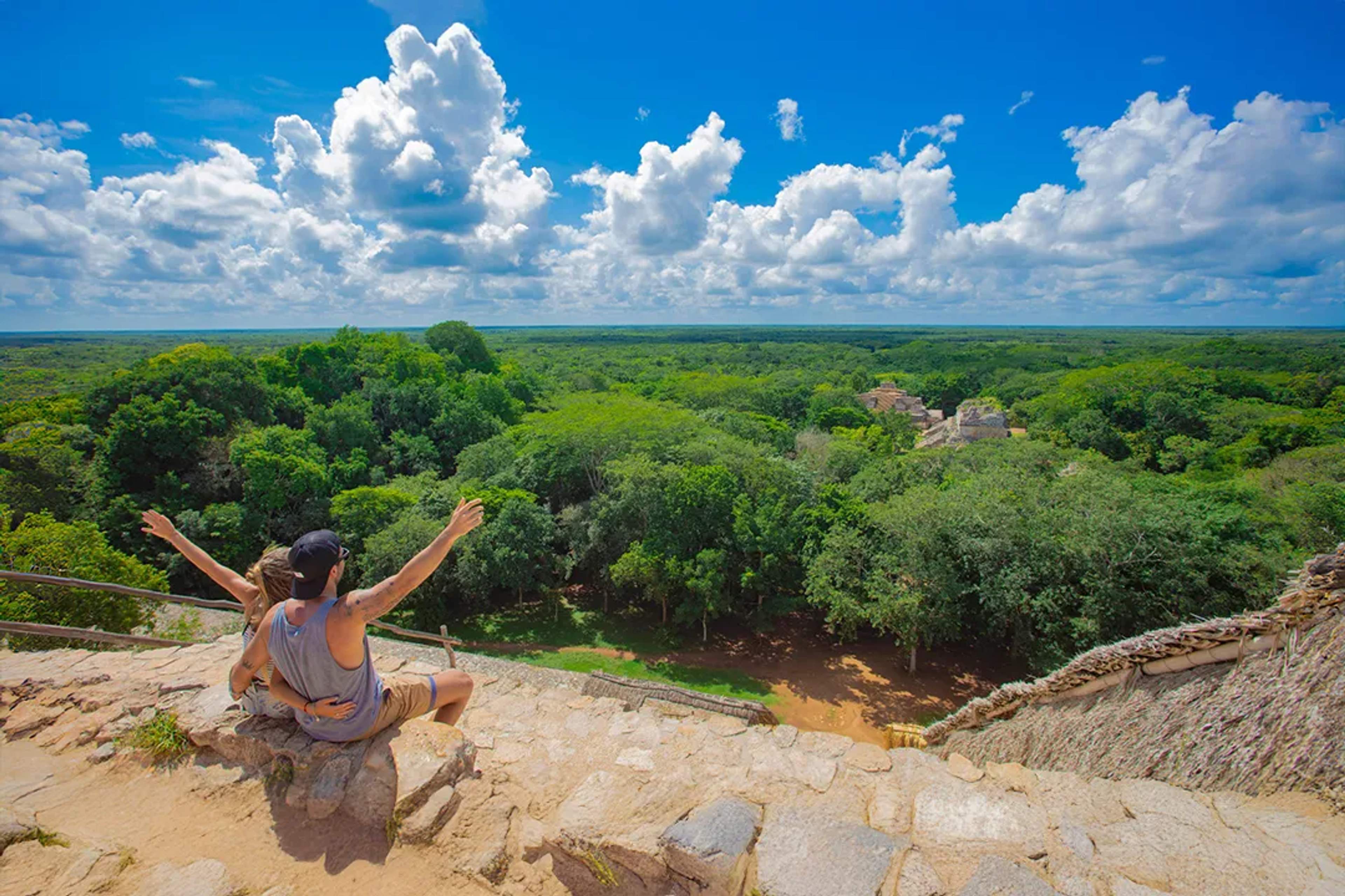 Couple enjoying jungle view at Ek Balam ruins, Yucatan Mayan site on guided cultural tour experience