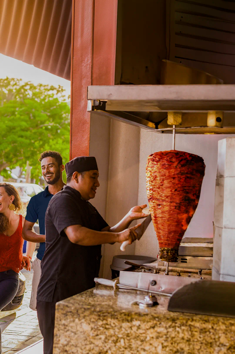 Viajeros disfrutando alguna de la mejor comida callejera en Cancún como parte de un tour guiado.
